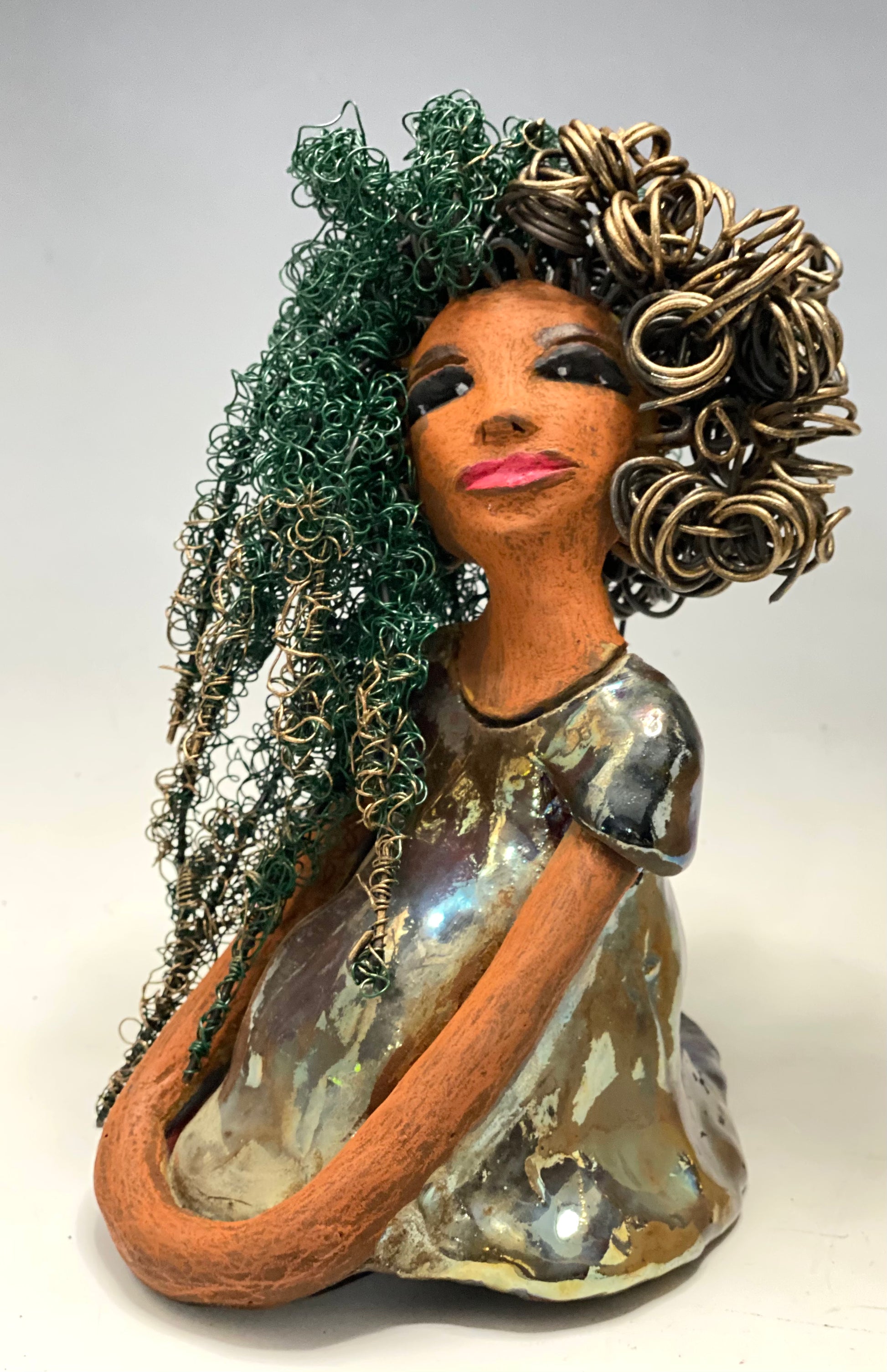 Diane stands 7" x 6" x 5.5" and weighs 1.9 lbs. She has a lovely honey brown complexion with reddish brown lips. She has long twisted wire locs hairstyle waist down!  Diane has a very colorful metallic  copper green antique glazed dress. She has over 75 feet of 16 and 24 gauge  wire for hair. It took over 6 hours just to do her hair! With  eyes wide opened, Diane has hope of finding a new home.