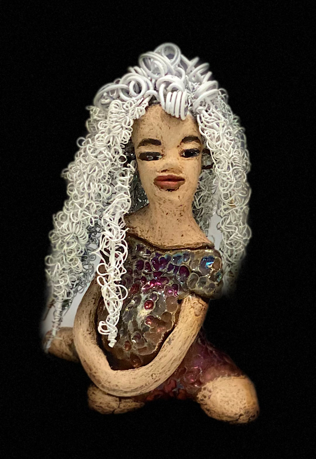 Alyssa stands 6" x 5" x 5" and weighs 12 ozs. She has a lovely honey brown complexion with cocoa brown lips. She has long twisted white wire locs hairstyle waist down! Alyssa has a metallic copper antique glazed dress. She has over 75 feet of 16 and 24 gauge white wire for hair. It took over 3 hours just to do her hair! With eyes wide opened, Brianna has hope of finding a new home. You will love having Alyssa. She will attract and spark conversation with guest in your home!