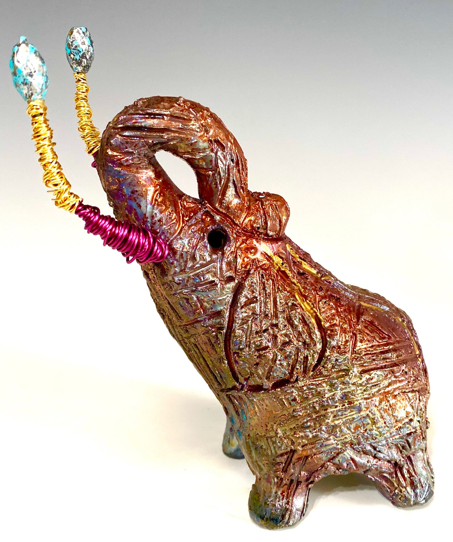 Raku Elephant Have you HERD!!!!!! Just one of these lovely Raku Fired Elephant will make an excellent gift for your friend, sorority or for your home’ special place centerpiece. 6" x 3" x 5" 1 lbs Beautiful metallic raku elephant For decorative purposely only