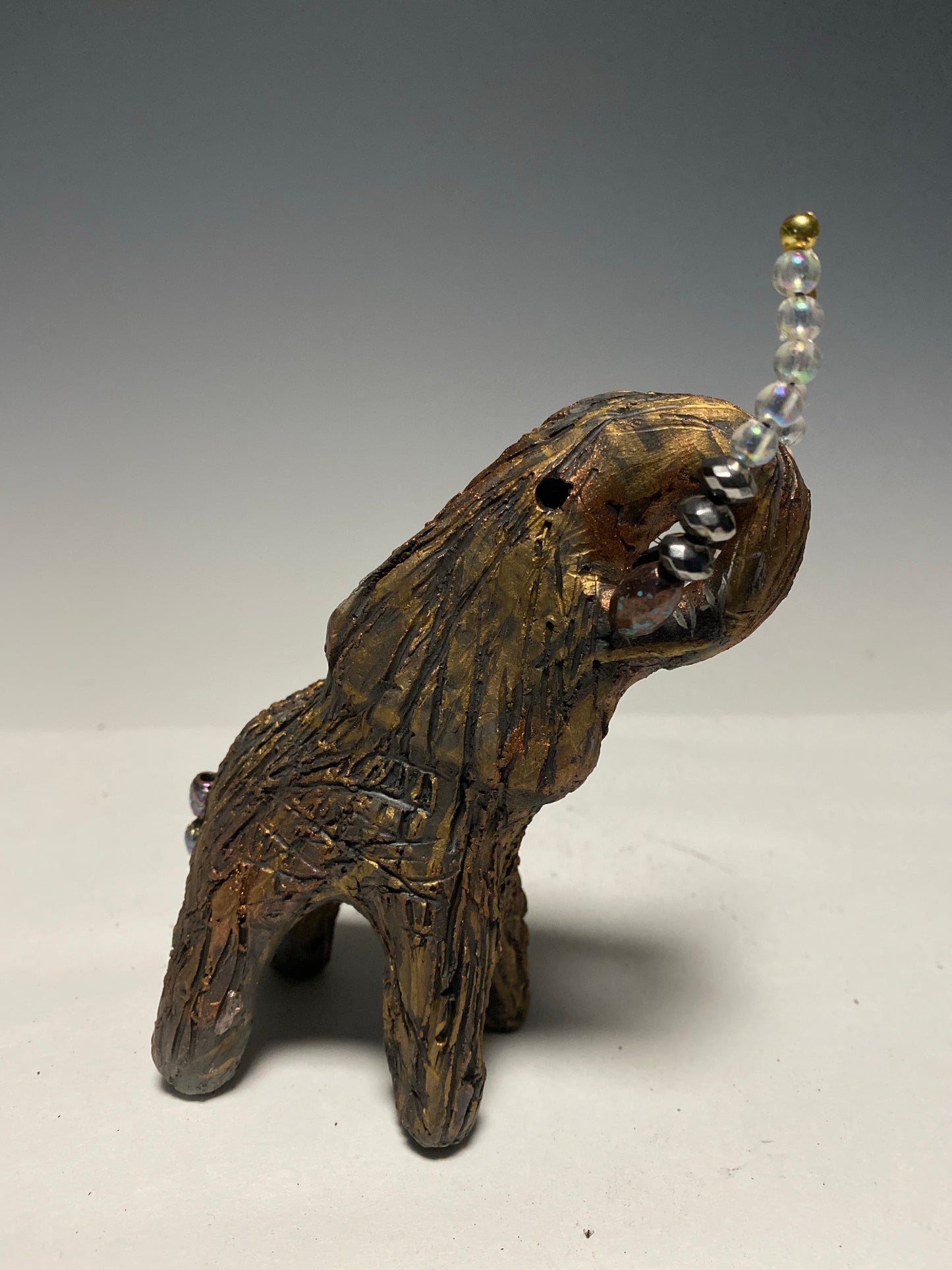 Have you HERD!!!!!! Elephants are one of my favorite animals to create. They are so majestic" Just one of these lovely Raku Fired Elephant will make an excellent gift for your BFF, or just for you . This raku fired baby elephant sits 6" x 4" x 4" and weighs 10 ounces. She has beaded tusks and a textured copper body. This little baby is Nice!