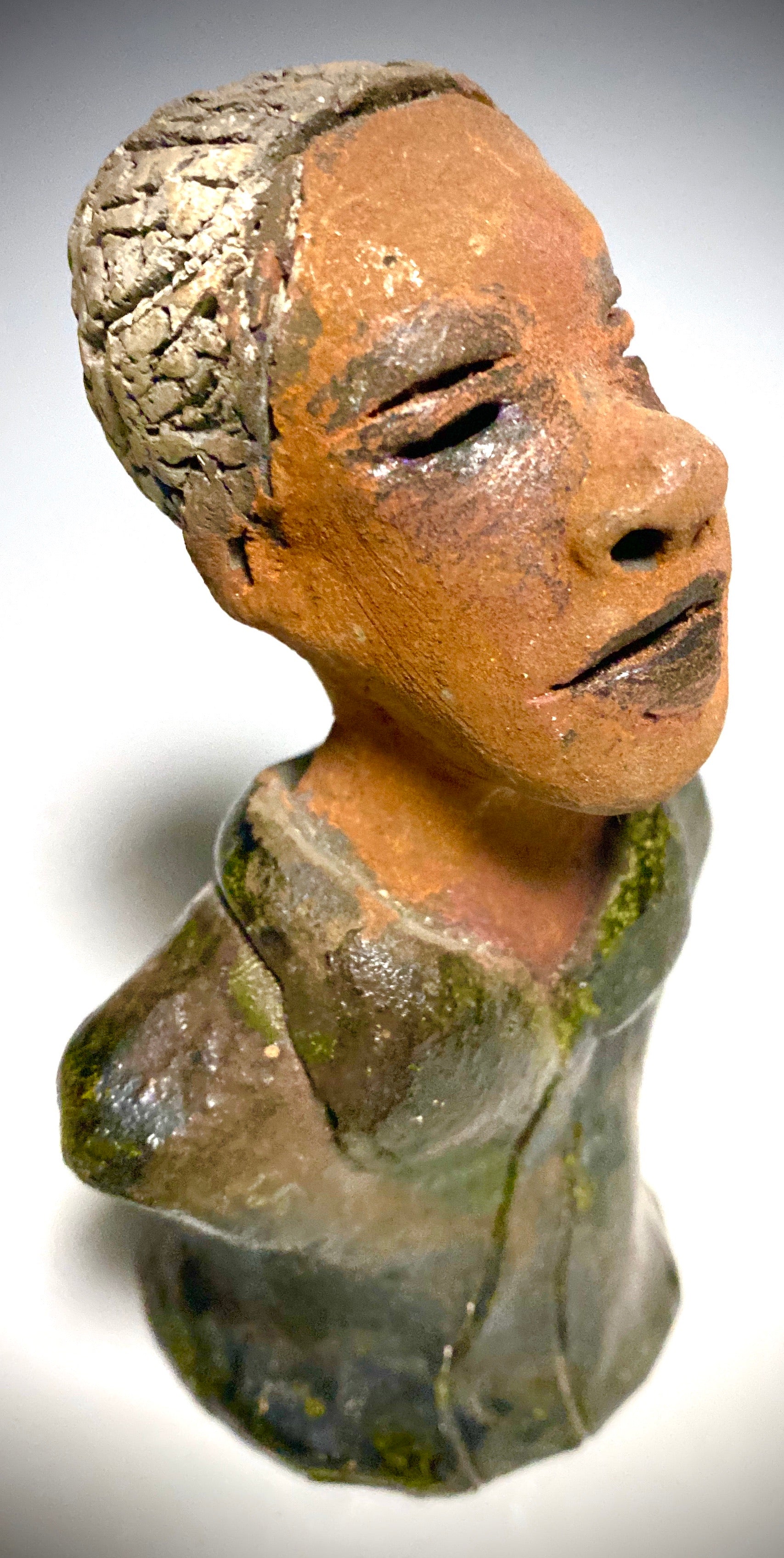 Mr. Charles has a story to tell!  Do you See the wisdom in his face? Mr. Charles  stands 5"x 3" x 2.5" and weighs 11 ozs. He wears a copper green metallic jacket. Mr. Charles's complexion is honey brown and he has salt and pepper hair.