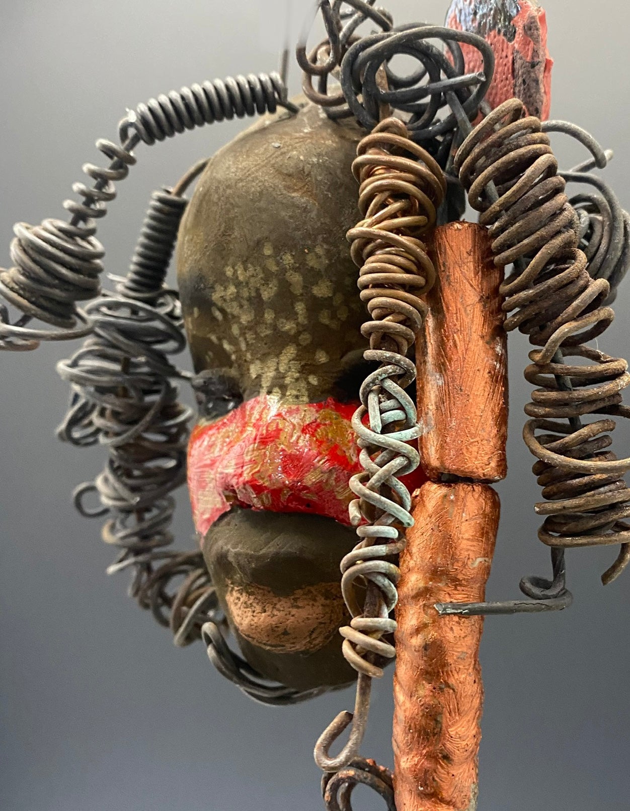 I started making art soon after seeing authentic African artwork at the Smithsonian Museum of African Art. I was in total awe. Gaby was inspired by my visit there. Gaby has a two tone complexion of earthy browns and bright red.. She is 5" x 4" and weighs 7.4 ozs. Gaby has 3 handmade raku fired beads. She has over 5 feet of coiled 16 gauge wire hair. Got Questions????