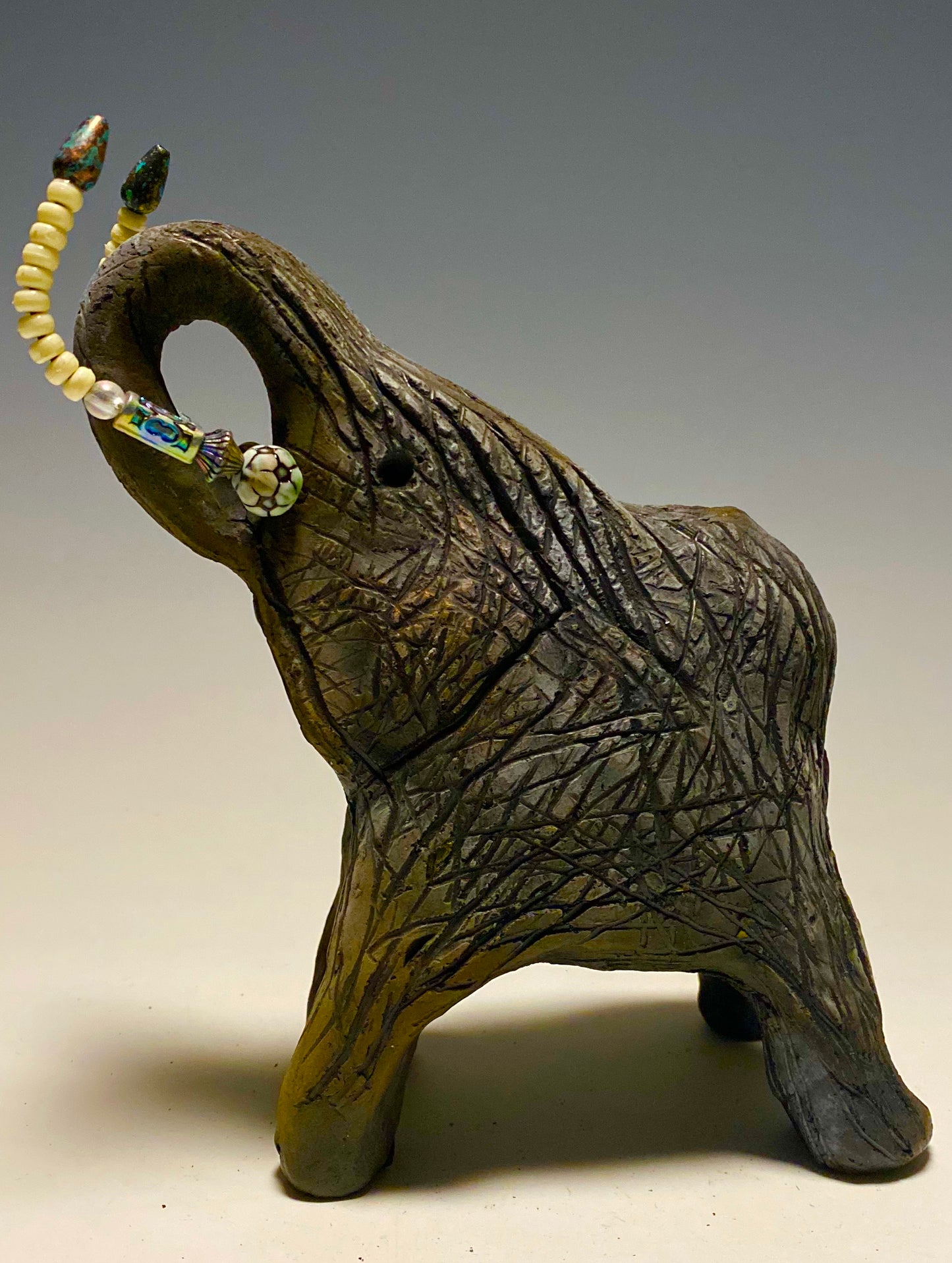 Raku Elephant Have you HERD!!!!!! Just one of these lovely Raku Fired Elephant will make an excellent gift for your friend, sorority or for your home’ special place centerpiece. 7" x 4" x 4" 1.7 lbs Beautiful metallic matte raku elephant For decorative purposely only