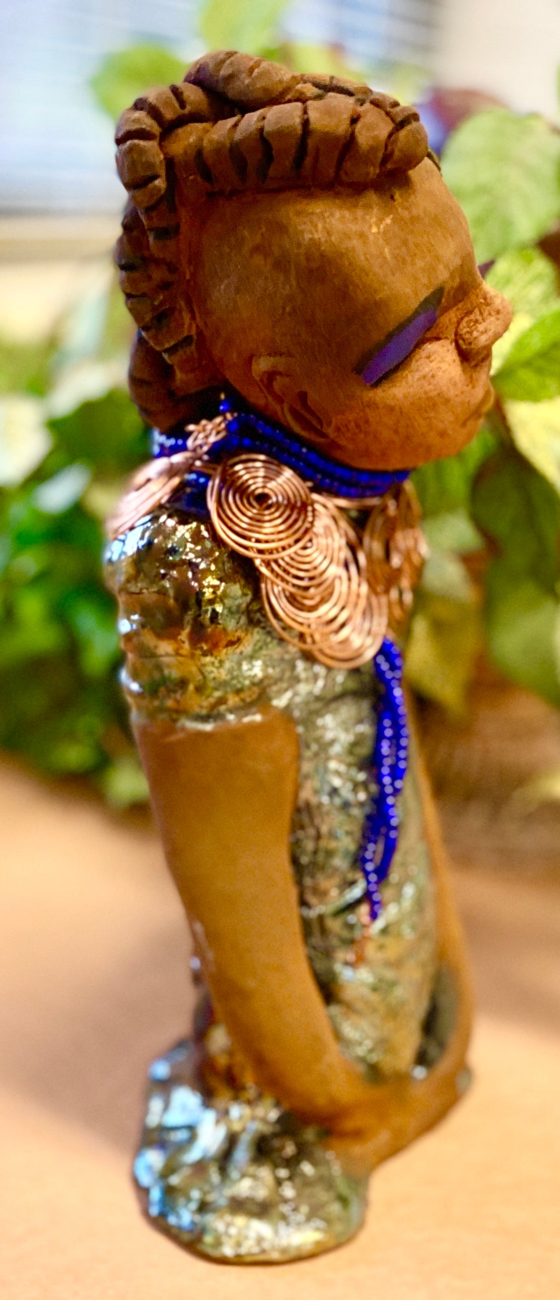 Georgia stands 11" x 5" x 3" and weighs 2.15 lbs. She has a honey brown complexion with a braided tribal clay hairstyle. She has an awesome copper metallic glitzy dress. Georgia has her long loving arms folded as she rest and waits. Give Georgia special place inside of your home.