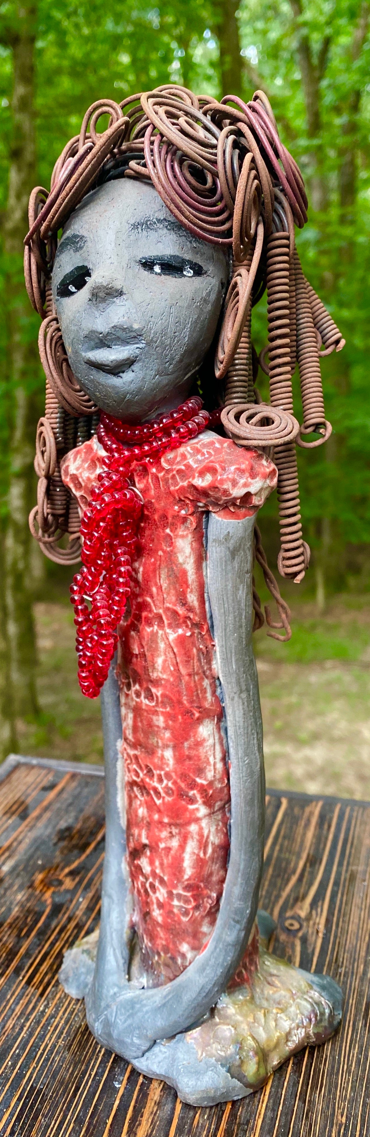 Meet Reagan! Reagan stands 12" x 4" x 4" and weighs 2.10 lbs. Reagan has a lovely dark complexion. It took over two hours to fix her Herdew! It is made of 16 gauge wire. Reagan has a shimmering metallic copper red dress. A strand of ruby red beads hangs around her neck. Reagan and her sister Carolyn are one of a kind. ( Sold Separately) Give Reagan and Carolyn a great Home!