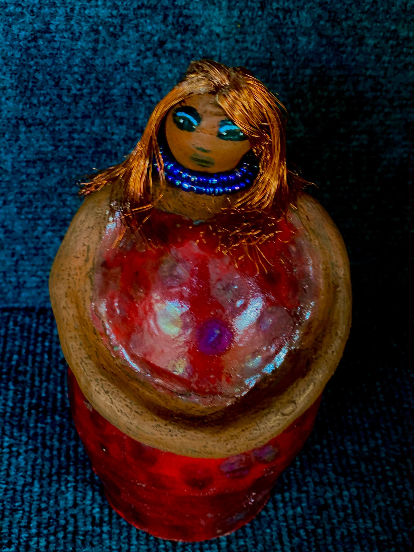 Meet Dora! She is a big girl who loves to sing and has aspirations of becoming a movie star. Dora stands 7" x 4" x 4.5" and weighs 1.06 lbs. She has a lovely honey brown complexion with lovely reddish brown lips. Dora has a lovely gold spotted heart glazed dress. She wears a beaded dark blue necklace. With eyes wide opened, Dora has hopes of finding a new home. Dora has a twin sister name Cora.