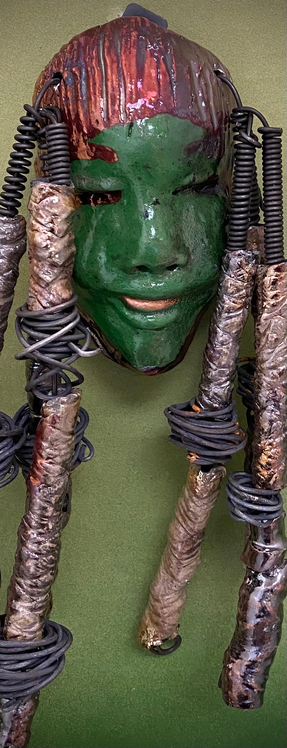 I started making art soon after seeing authentic African artwork at the Smithsonian Museum of African Art. I was in total awe. Bryce was inspired by my visit there. Bryce is 4”x 10” and weighs 1 lbs. She has an awesome emerald green complexion. Bryce wears a textured copper headdress with textured metallic white spiral coiled beads of hair. Bryce is ready to be installed in your home!