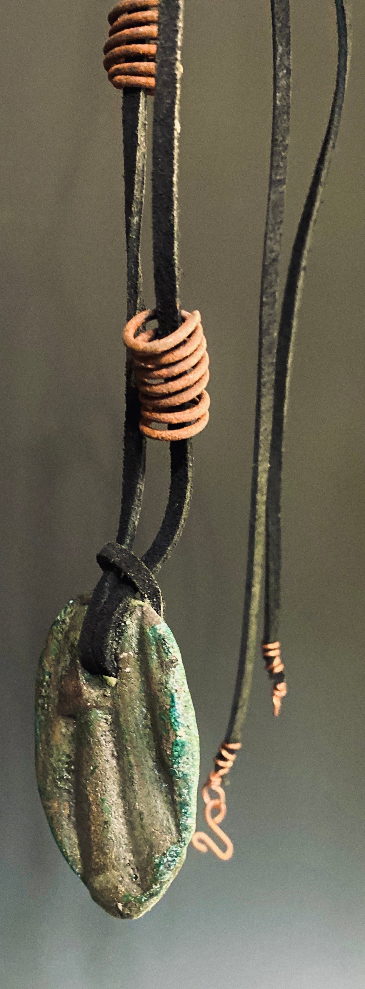 Earthy! 16"  brown suede cord. 1  earthy colored Raku disc spiral wire coils Tribal!