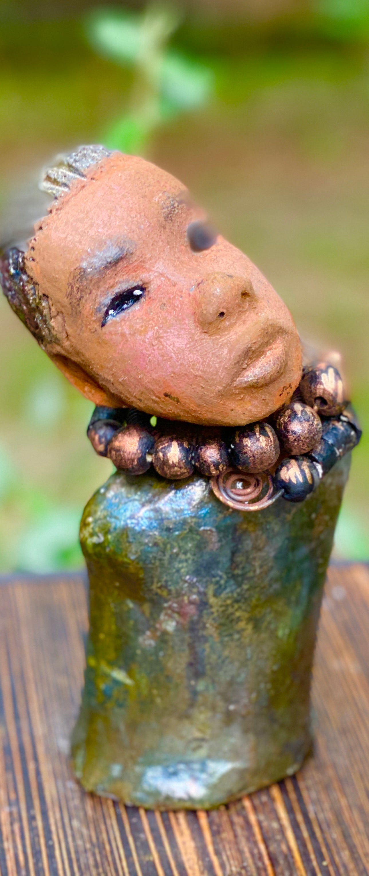 "It is obvious Herdew implies that most of my sculptures are female. My goal this year is to create ten male sculptures. Alvin is one of the first that I am pleased with. Alvin stands 9" x 4" x 4" and weighs 2.13 lbs. He wears a metallic multi colored jacket with metallic beads. Alvin has a dark honey brown complexion. Alvin seems to be in deep thought. Alvin would display proudly in your home.