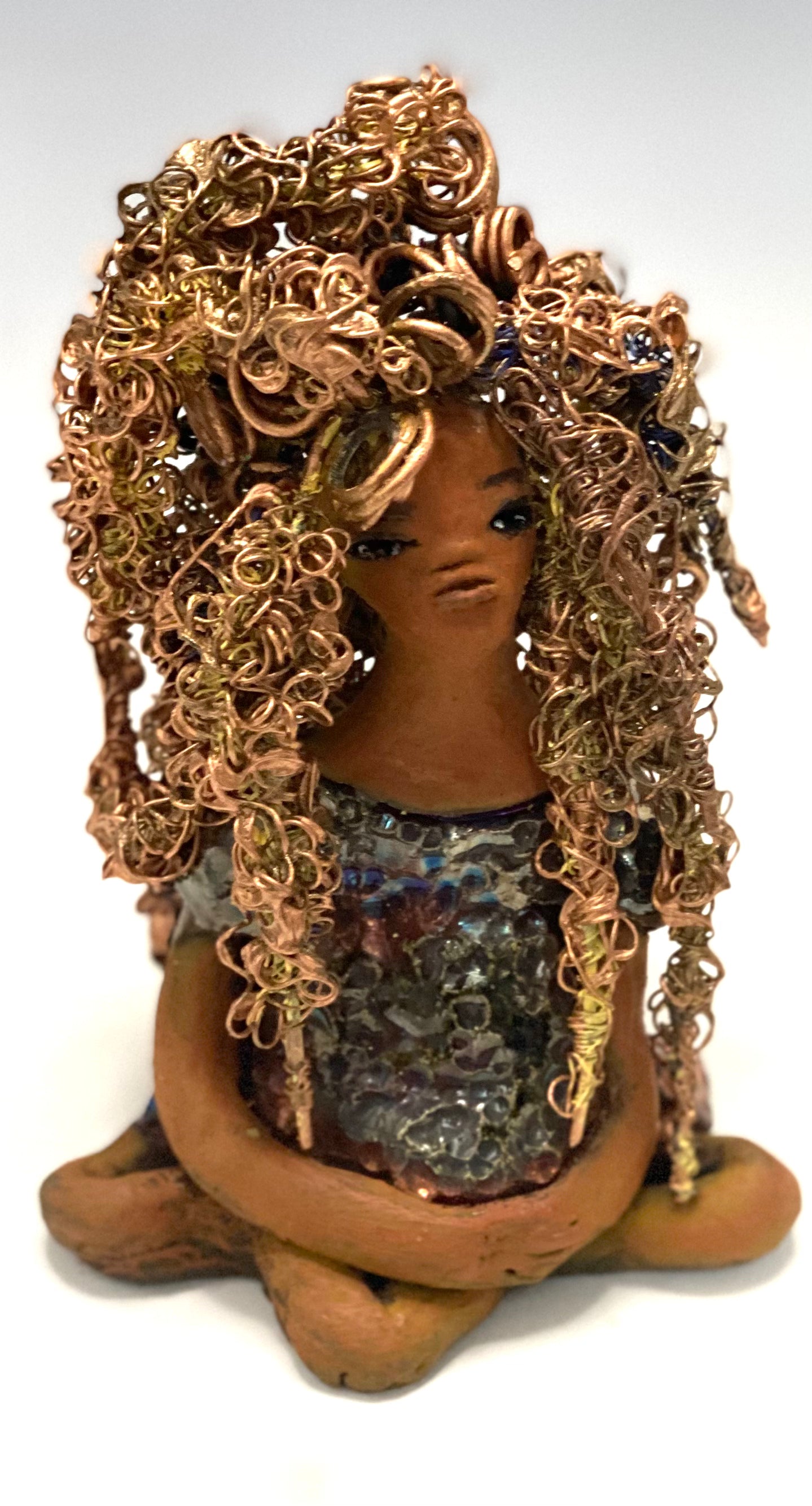 Meet Tiana! Tiana stands 5" x 3.5" x 3.5" and weighs 10 ozs. She has a lovely honey brown complexion. Tiana's dress is metallic copper. She has her long loving arms resting at her side. " I am really pleased with Tiana's blue beaded necklace and her new wire hair Find a place in your space for Tiana!