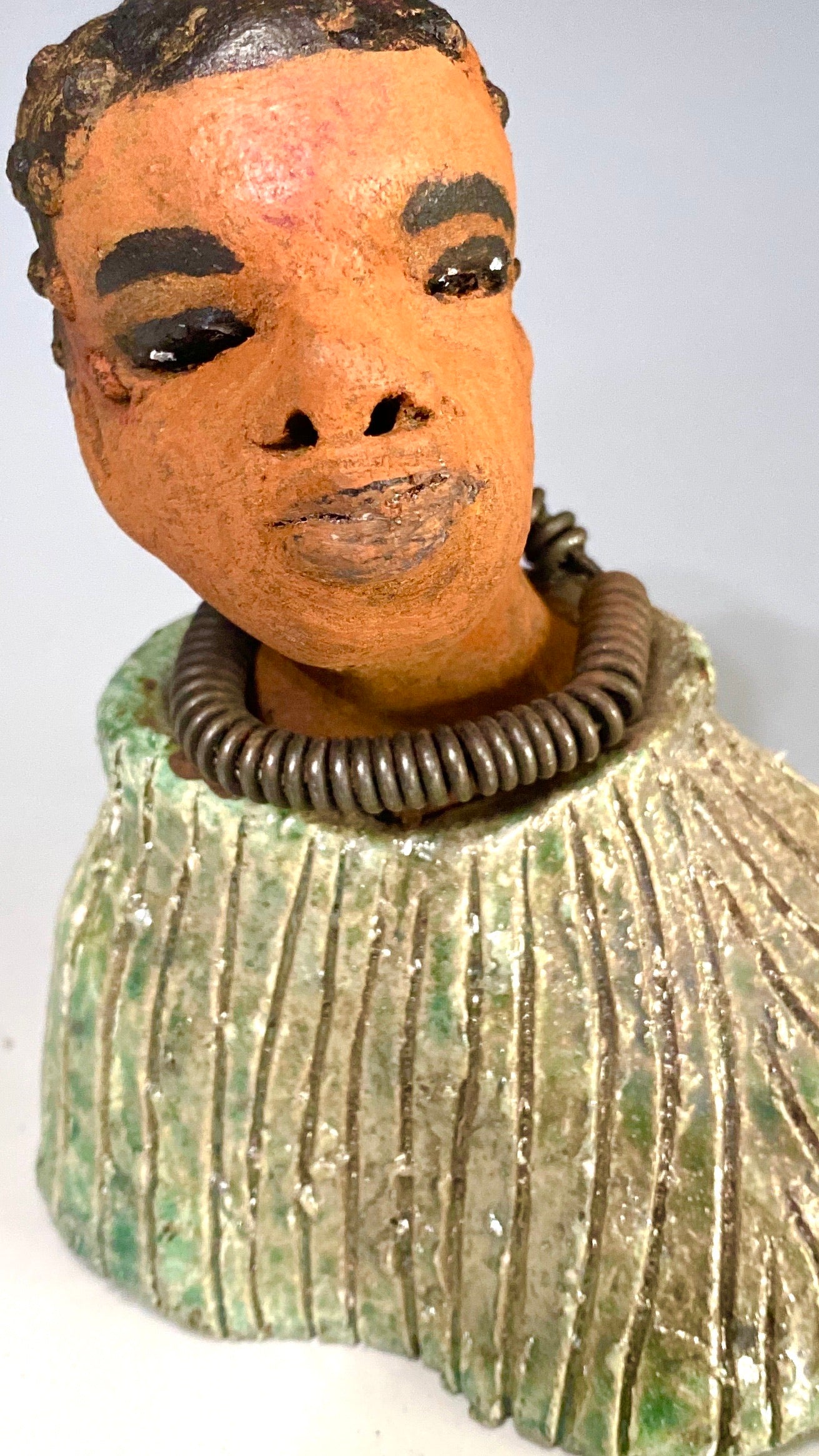 "It is obvious Herdew implies that most of my sculptures are female. My goal this year is to create ten male sculptures. Alvin is one of the first that I am pleased with. Pete stands 5" x 4" x 3" and weighs 10 ozs. He wears an etched metallic multi colored jacket with a cioled wire necklace. Pete has a honey brown complexion. Pete seems to be in deep thought about his next move in life. Pete  would display proudly in your home.