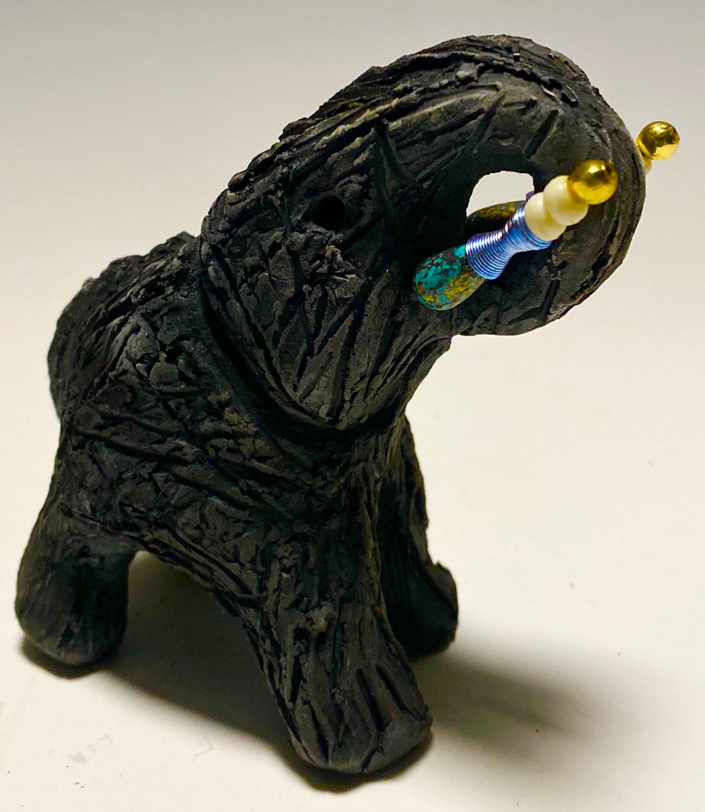 Have you HERD!!!!!! Elephants are one of my favorite animals to create. They are so majestic" Just one of these lovely Raku Fired Elephant will make an excellent gift for your BFF, or just for you . This raku fired elephant stands 4" x 2" x 2.5" and weighs 7 ounces. She has beaded tusks and a textured charcoal body. Nice!