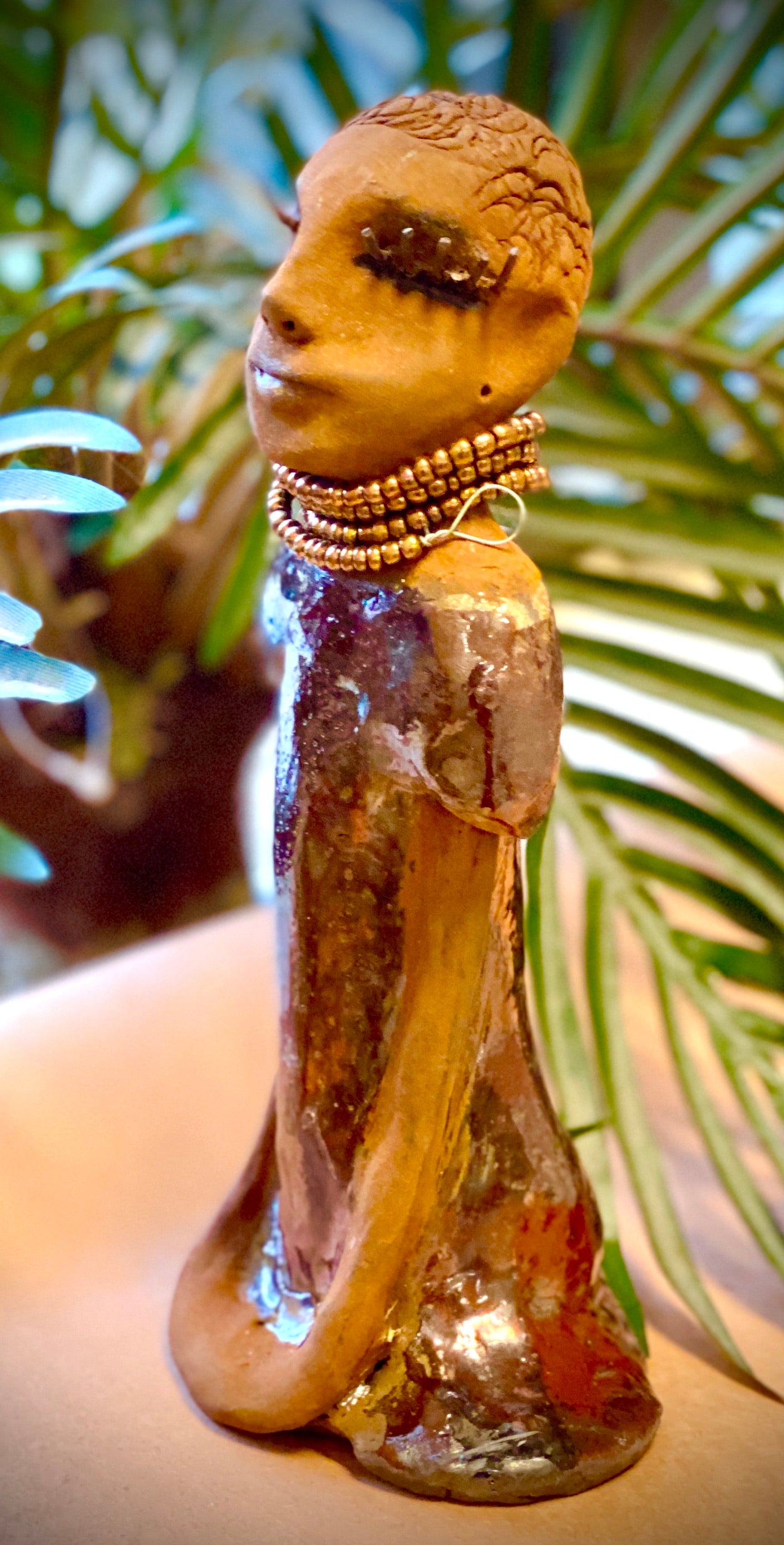 Meet Morgan! Morgan stands 9' x 4"x 3.5" and weighs 1 lbs. She has bright honey brown complexion. Her dress is a s Morgan wears an amber beaded necklace Her long trademark arms rest at her side. Morgan is waiting for a new home!
