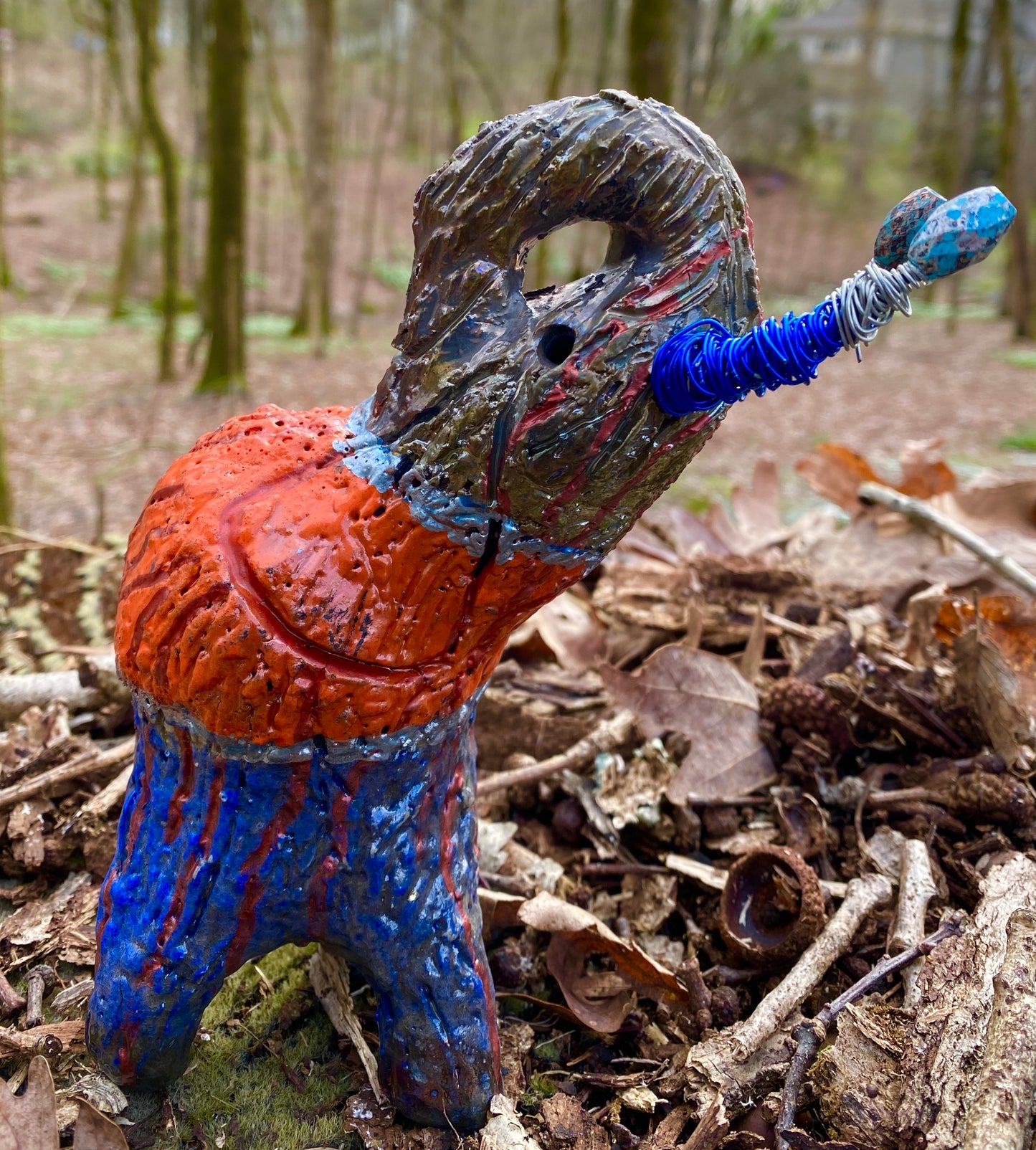 Have you HERD!!!!!! Just one of these lovely Raku Fired Elephant will make an excellent gift for your friend, sorority or for your home’ special place centerpiece. 7" x 4" x 4" 15 ozs. Blue wire beaded blue and silver tusk Beautiful metallic blue and orange raku colors For decorative purposely only.