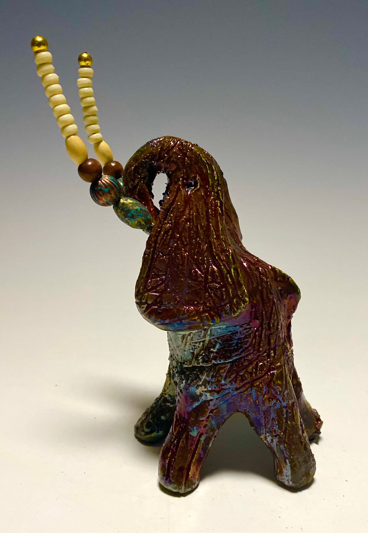 Raku Elephant Have you HERD!!!!!! Just one of these lovely Raku Fired Elephant will make an excellent gift for your friend, sorority or for your home’ special place centerpiece. 6" x 4" x 4" 1.7 lbs Beautiful copper metallic baby raku elephant Beaded white tusk. For decorative purposely only. Great Gift!