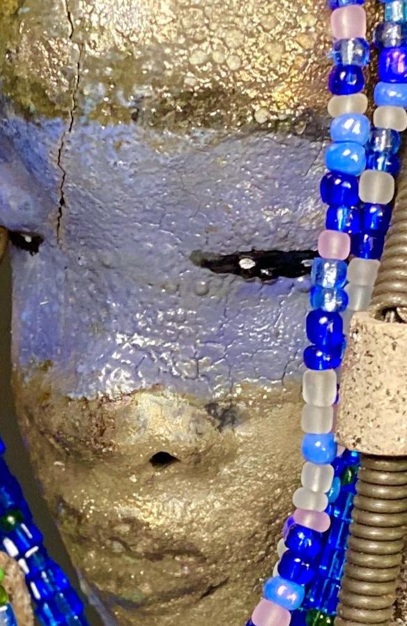 Meet Randi! I started making art soon after seeing authentic African artwork at the Smithsonian Museum of African Art. I was in total awe. Randi was inspired by my visit there. Randi has a two tone complexion of golden silver and blue. She is 8" x 6" and weighs 14 ozs. Randi has over 10 raku beads. She has over 200 of multi shade of blue and white mini beads. Randi has over 10 feet of coiled copper and 16 gauge wire hair.