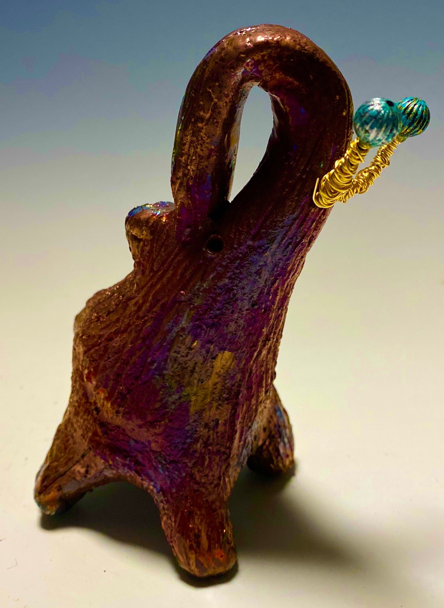 Have you HERD!!!!!! Elephants are one of my favorite animals to create. They are so majestic" Just one of these lovely Raku Fired Elephant will make an excellent gift for your BFF, or just for you . This raku fired elephant stands 6" x 2" x 2.5" and weighs 12 ounces. She has beaded tusks and a textured copper metallic body. Perfect for a gift or to add to your collection.