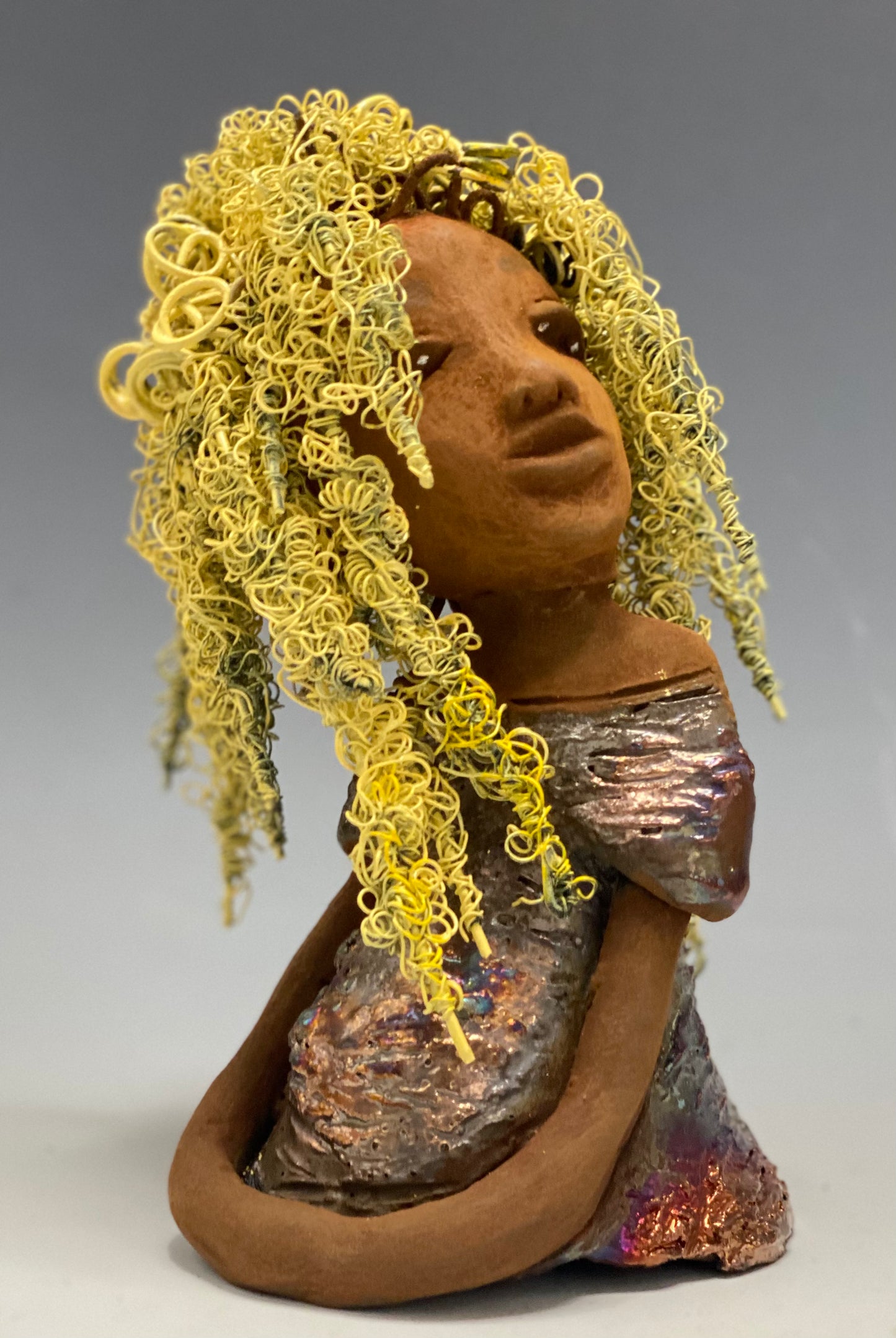 Valorie stands 8" x 4.5" x 4.5" and weighs 1.05 lbs. She has a lovely honey brown complexion with cocoa brown lips. She has long twisted wire locs hairstyle waist down! Valorie has a metallic copper antique glazed dress. She has over 75 feet of 16 and 24 gauge pale yellow wire for hair. It took over 7 hours just to do her hair! With eyes wide opened, Valorie has hope of finding a new home.
