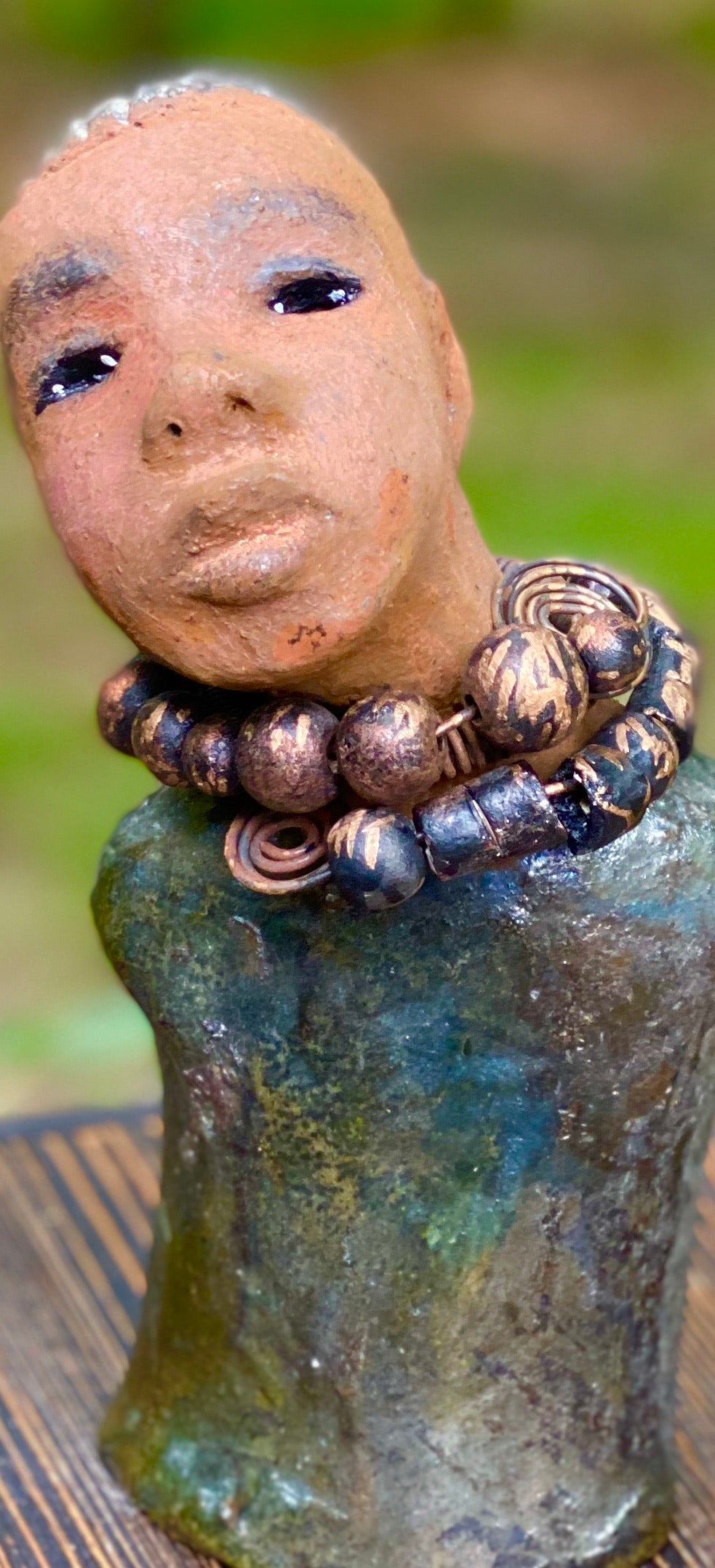"It is obvious Herdew implies that most of my sculptures are female. My goal this year is to create ten male sculptures. Alvin is one of the first that I am pleased with. Alvin stands 9" x 4" x 4" and weighs 2.13 lbs. He wears a metallic multi colored jacket with metallic beads. Alvin has a dark honey brown complexion. Alvin seems to be in deep thought. Alvin would display proudly in your home.