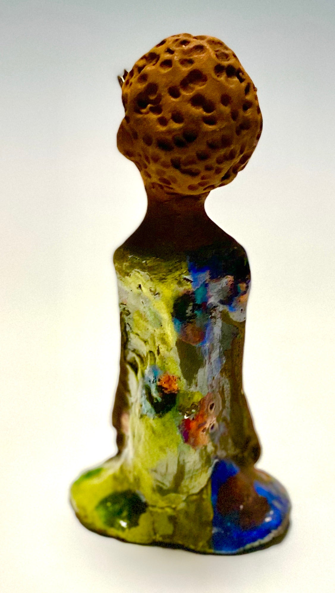 Adisa stands 7' x 4"x 2" and weighs 10.3 ozs. She has bright dark eyes and a nice honey two tone brown complexion Her long trademark arms rest at her side. Adisa dress is a loving glossy blue and yellow mix with copper flashes.