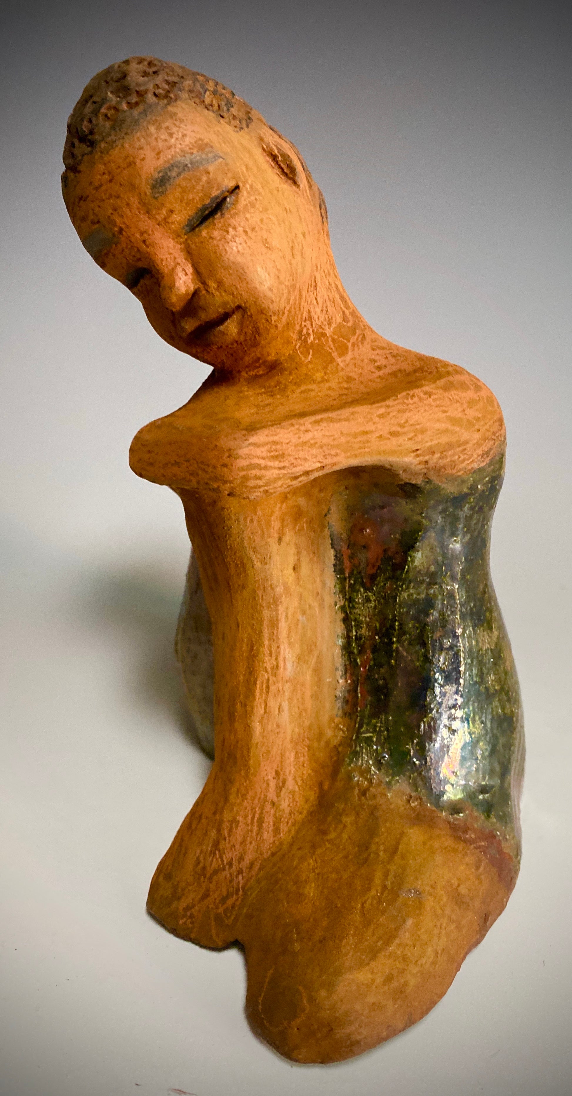 Carlos is one teen who will think before he reacts!   Carlos stands  6.5" x 4" x 5" and weighs 1.7 lbs. He wears a matching metallic green shirt and jeans . Carlos complexion is honey brown. He is thoughtful with a gentle spirit His  arms  are wrapped around  his knees as he waits on you.
