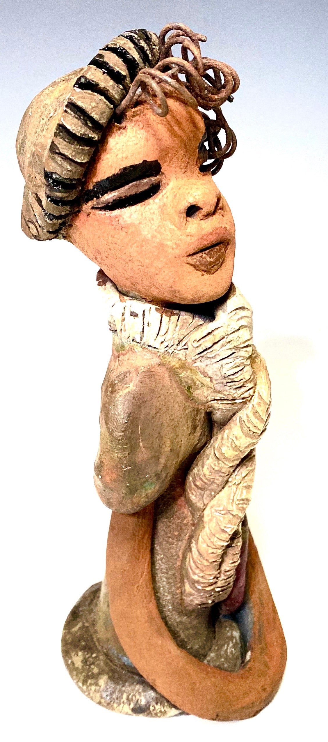 Lorie sits 8" x 3 x 3" and weighs 1.11 lbs. Lorie complexion is cocoa brown. She wears a  dark brown metallic and matte dress. Lorie sits with her arms and purse at her side. She will be a great gift or bring happiness to your home!
