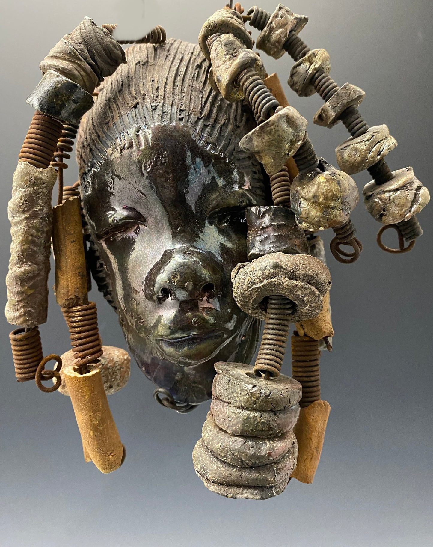 Meet JoAnne I started making art soon after seeing authentic African artwork at the Smithsonian Museum of African Art. I was in total awe. JoAnne was inspired by my visit there. JoAnne has a two tone complexion of black and dark metallic copper. She is 8" x 6" and weighs 14 ozs. Adisa has over 15 handmade raku fired beads. She has over 10 feet of coiled 16 gauge wire hair.