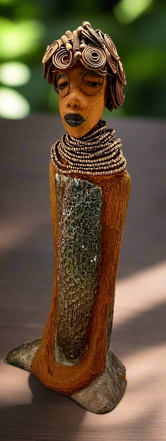 Meet Ernestine! Ernestine stands 18' x 6" x 5" and weighs 5.03 lbs. Ernestine has a lovely honey brown complexion. She has a shimmering copper dress with a huge seed bead necklace. Ernestine is a tall girl with long loving arms. It took several hours to style Ernestine's 16 gauge wire hair! With eyeglasses ,she looks as if she's dreaming or in disbelief. Ernestine is indeed a sophisticated looking lady!   Give Ernestine a new place to stay in your home!