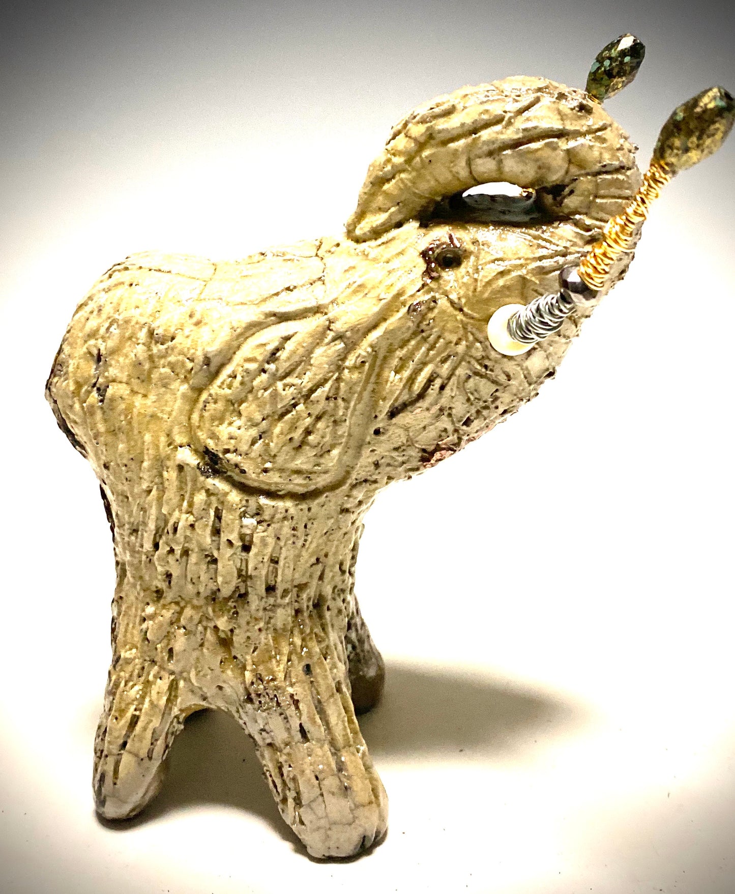 Raku Elephant Have you HERD!!!!!! Just one of these lovely Raku Fired Elephant will make an excellent gift for your friend, sorority or for your home’ special place centerpiece. 6" x 3" x 4" 1.3 lbs Beautiful metallic white raku elephant For decorative purposely only