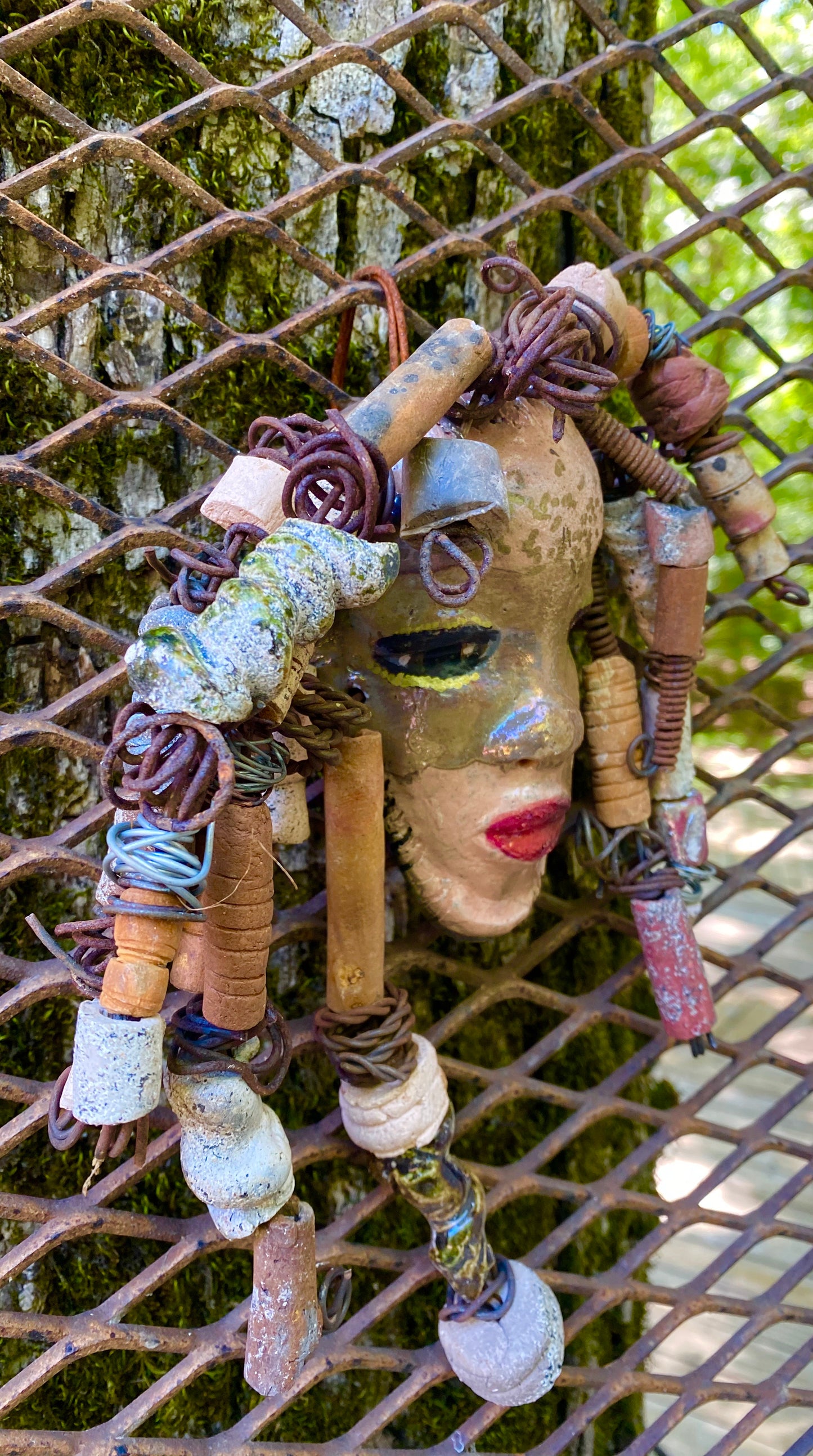 I started making art soon after seeing authentic African artwork at the Smithsonian Museum of African Art. I was in total awe. Brenanna was inspired by my visit there. Brenanna has a two tone copper gold complexion. She is 9" x 9" and weighs 1 lbs. Brenanna has over 25 handmade raku fired beads. Brenanna has over 15 feet of coiled 16 gauge wire hair.