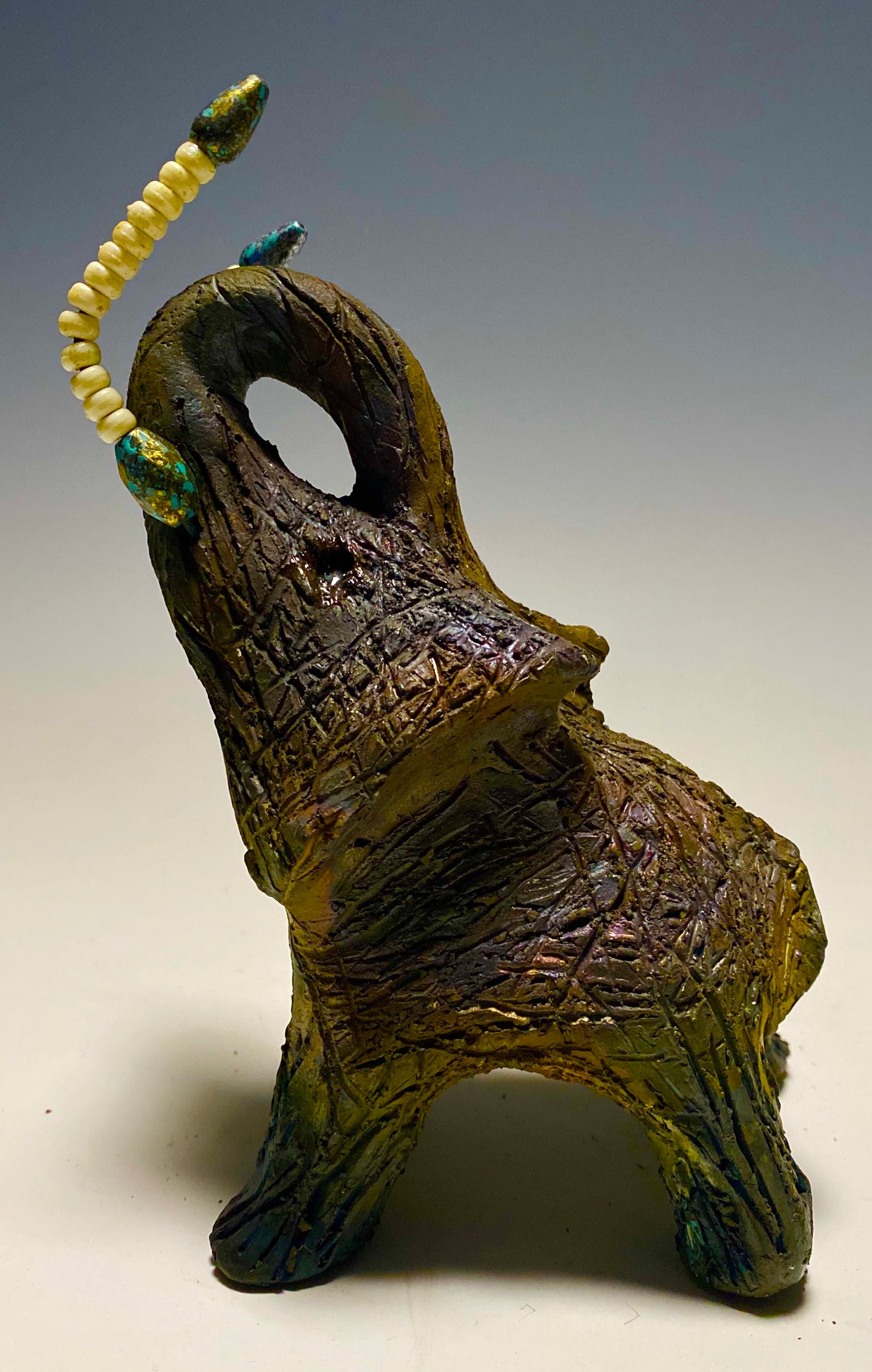 Have you HERD!!!!!! Elephants are one of my favorite animals to create. They are so majestic" Just one of these lovely Raku Fired Elephant will make an excellent gift for your BFF, or just for you . This raku fired elephant stands 6" x 4" x 5" and weighs 1 lb. She has beaded tusks and a textured charcoal and copper metallic body. This one is nice to add your Herdew Collection!