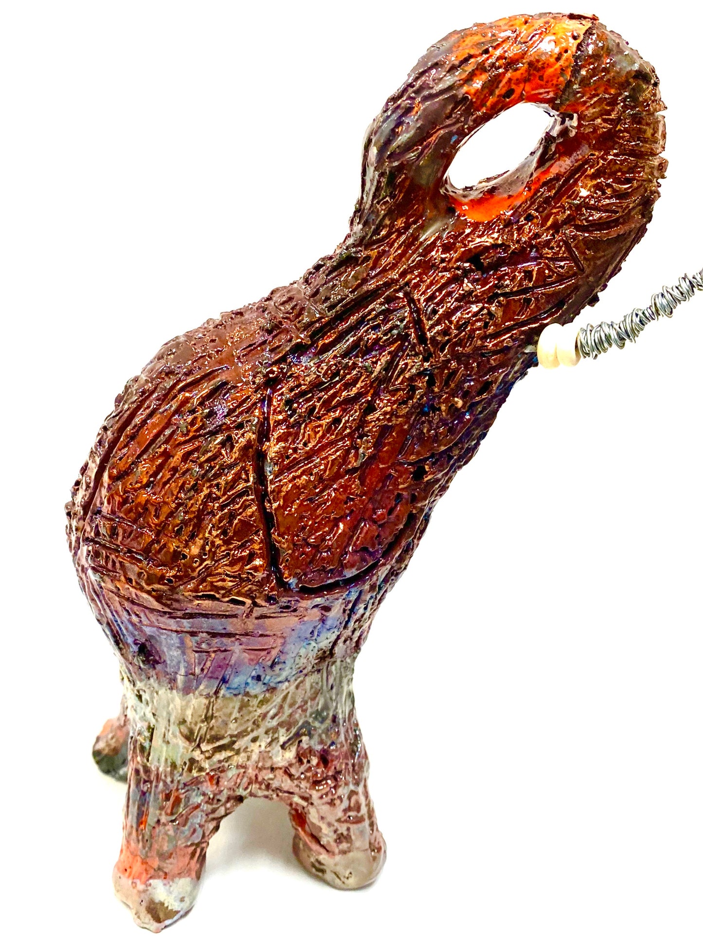 Raku Elephant Have you HERD!!!!!! Just one of these lovely Raku Fired Elephant will make an excellent gift for your friend, sorority or for your home’ special place centerpiece. 8" x 4" x 4" 1.7 lbs Beautiful orange copper metallic raku elephant Beaded white tusk with silver wire. For decorative purposely only. Great Gift!