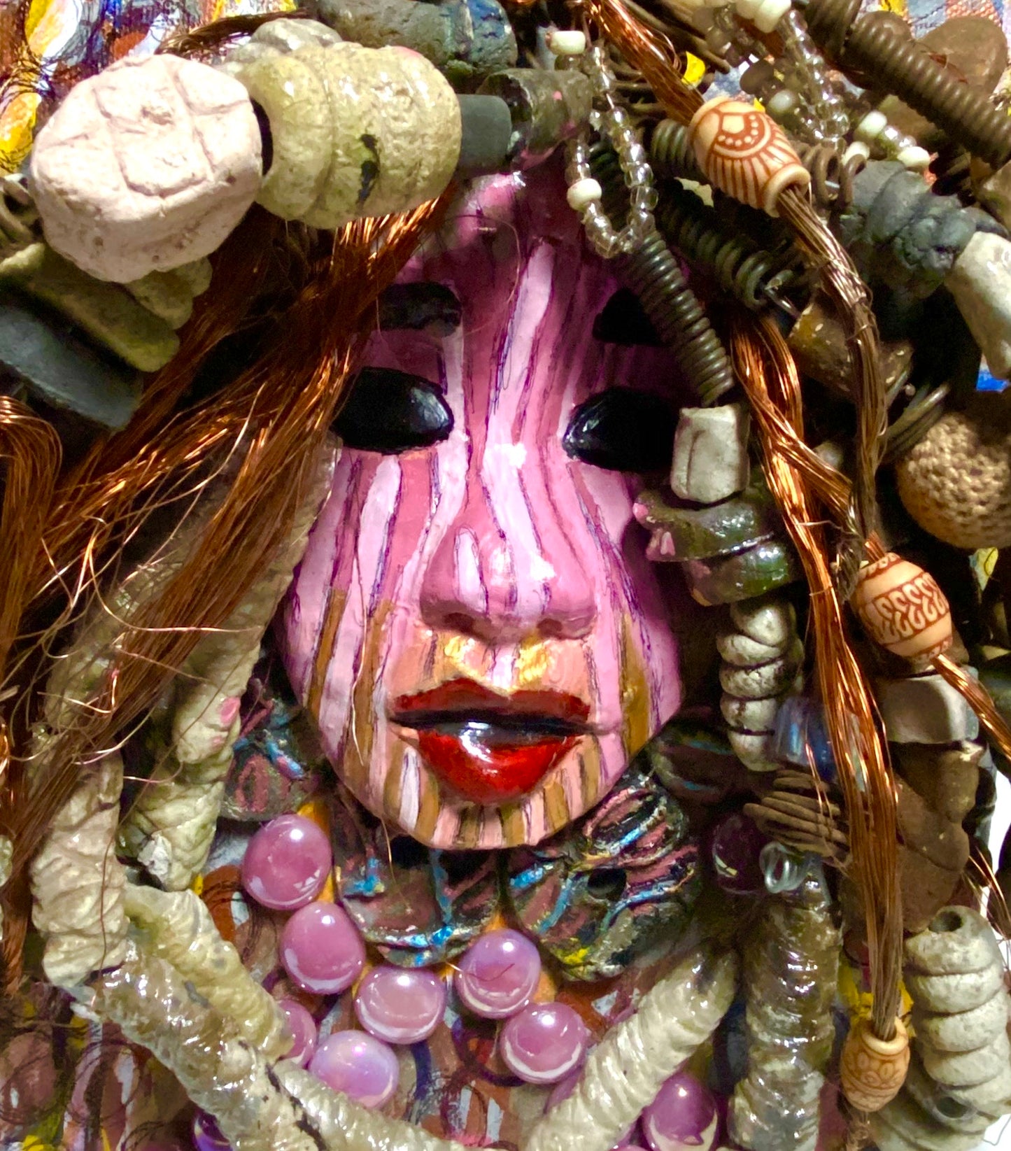 Sabra is mounted on a 8"x 10"painted canvas. I spent about 4 hours or more just fixing April's hair and attaching her beads! She has over 60 feet of 16 gauge wire with multiple strands of copper wire for hair and over 50 raku beads. Sabra has a striped pink crackle face with and ruby red lips. She is ready to be hung!