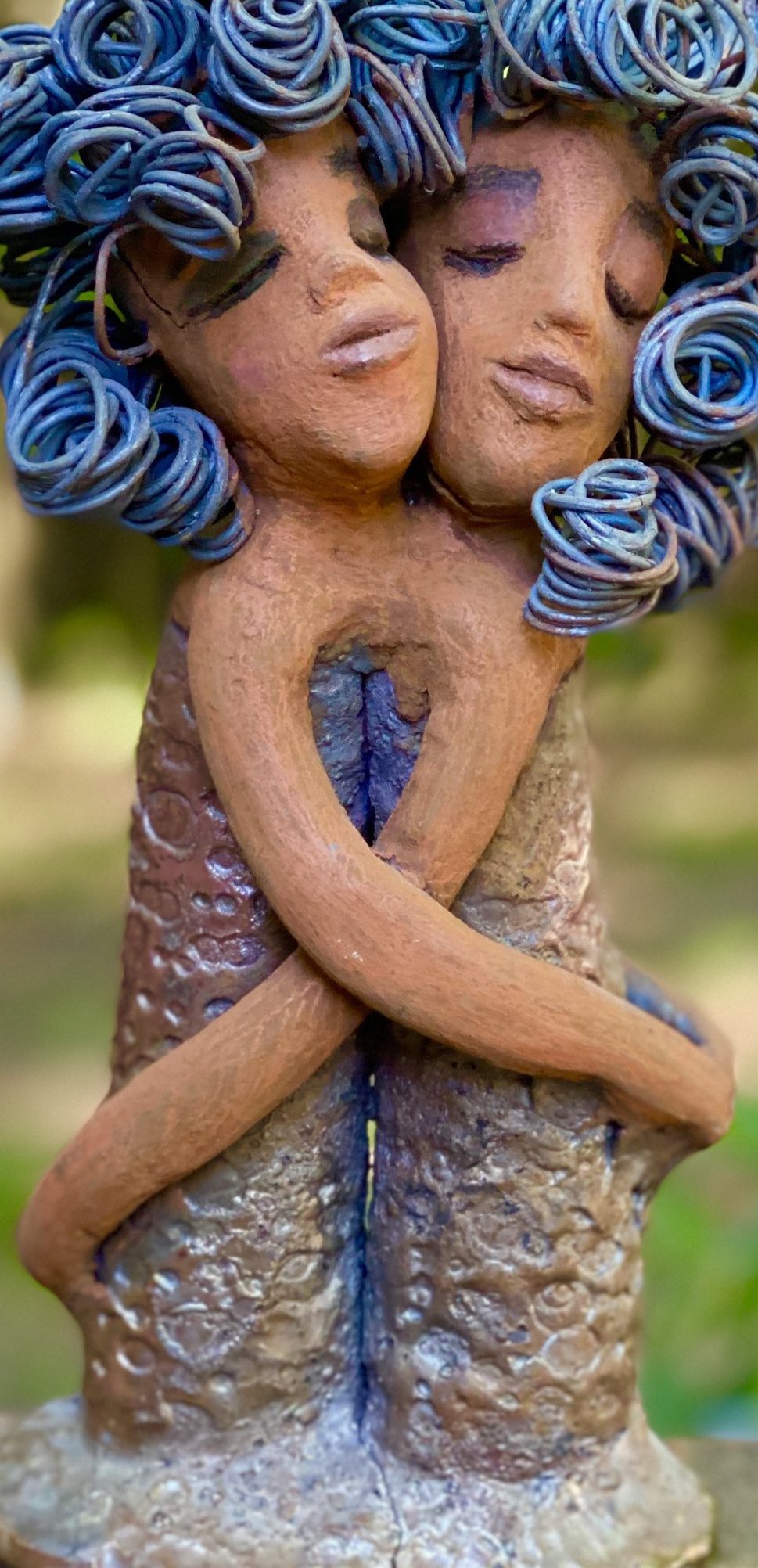 Sister Love is a raku fired sculpture. Raku is a specialized firing technique that involves high heat and open flames. Sister Love stands 11" x 5" x 3" and weighs 2.06 lbs. Combined they have over 45 feet of curled 16 gauge wire hair. The dresses are textured with an antique copper glaze. They have lovely honey brown complexions and long loving arms. Sister Love is inseparable! Give them a special place in your home. Free Shipping!