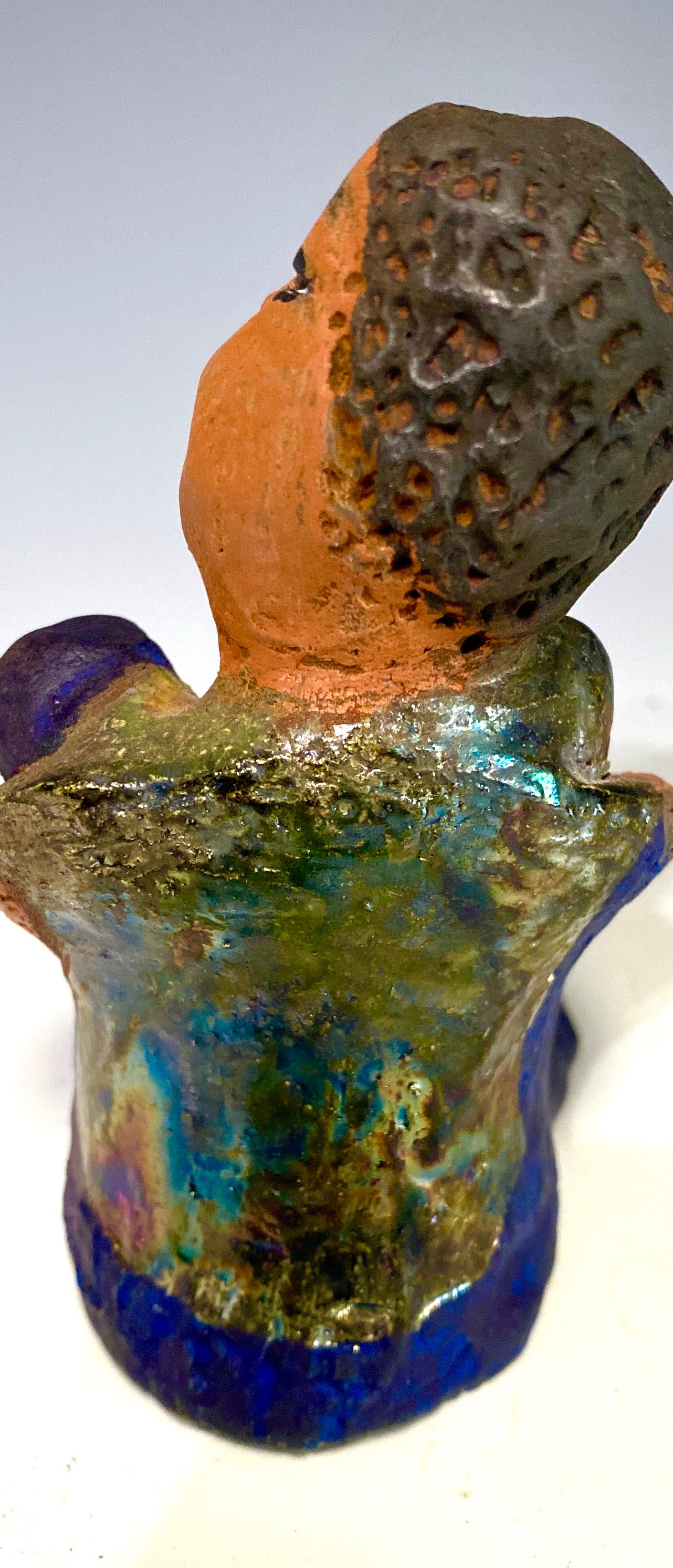 Paul is a Handsome Mischief Guy! Do you see the wit in his face? Paul stands 4.5"x 3" x 3" and weighs 6.9 ozs. He has a shimmery metallic tee shirt. Paul's complexion is honey brown. His arms are folded around his legs as he ponders another mischief moment!