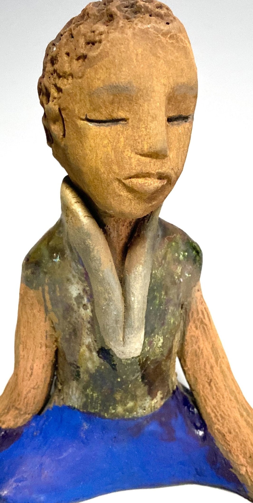 Travis is one teen who does respect his elders.   Travis stands  5" x 4" x 3" and weighs 9 ozs. He wears a metallic green shirt with blue jeans . Travis complexion is honey brown. He is thoughtful with a gentle spirit His  arms rest at his knees as he waits on you.