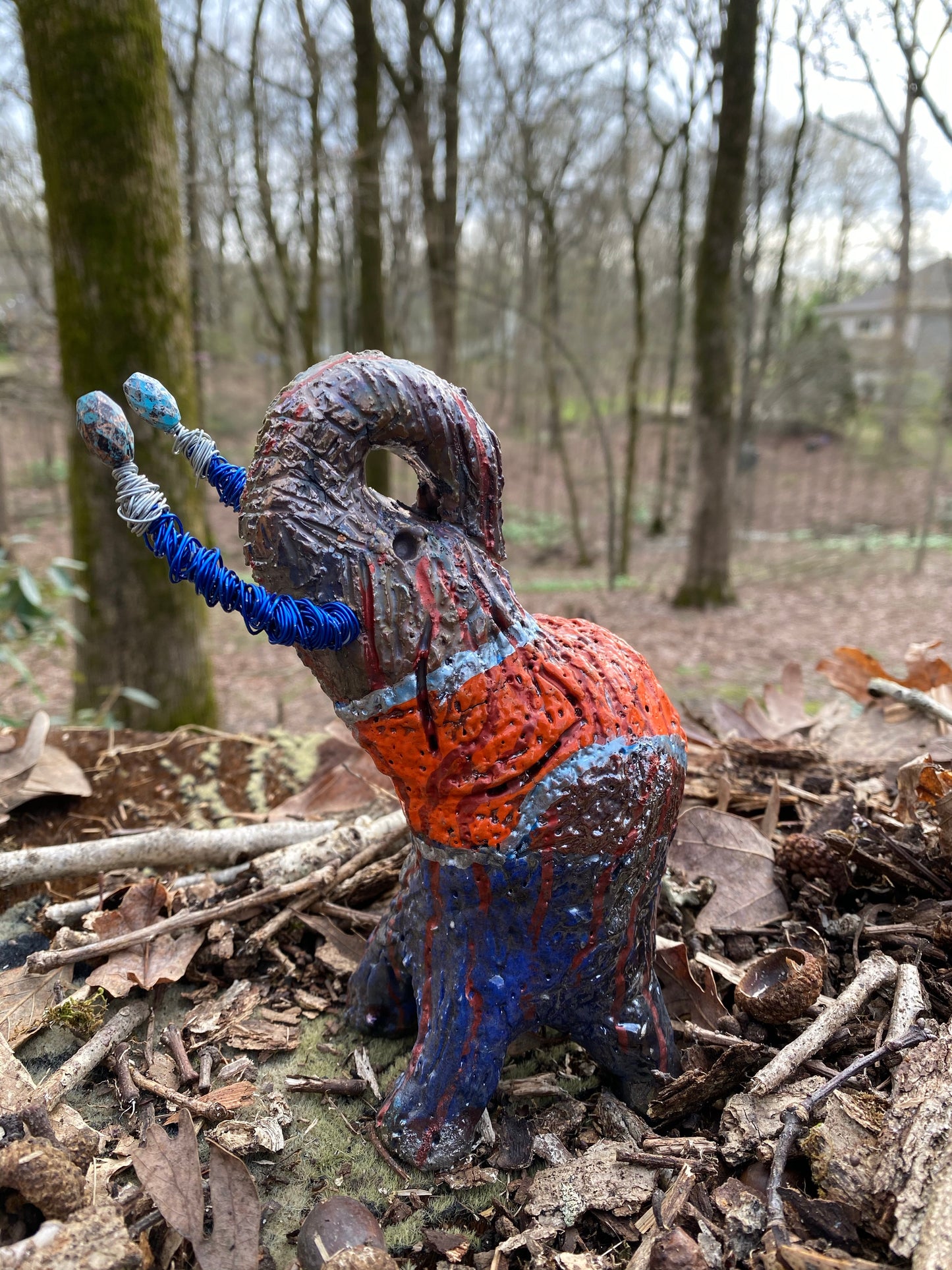 Have you HERD!!!!!! Just one of these lovely Raku Fired Elephant will make an excellent gift for your friend, sorority or for your home’ special place centerpiece. 7" x 4" x 4" 15 ozs. Blue wire beaded blue and silver tusk Beautiful metallic blue and orange raku colors For decorative purposely only.