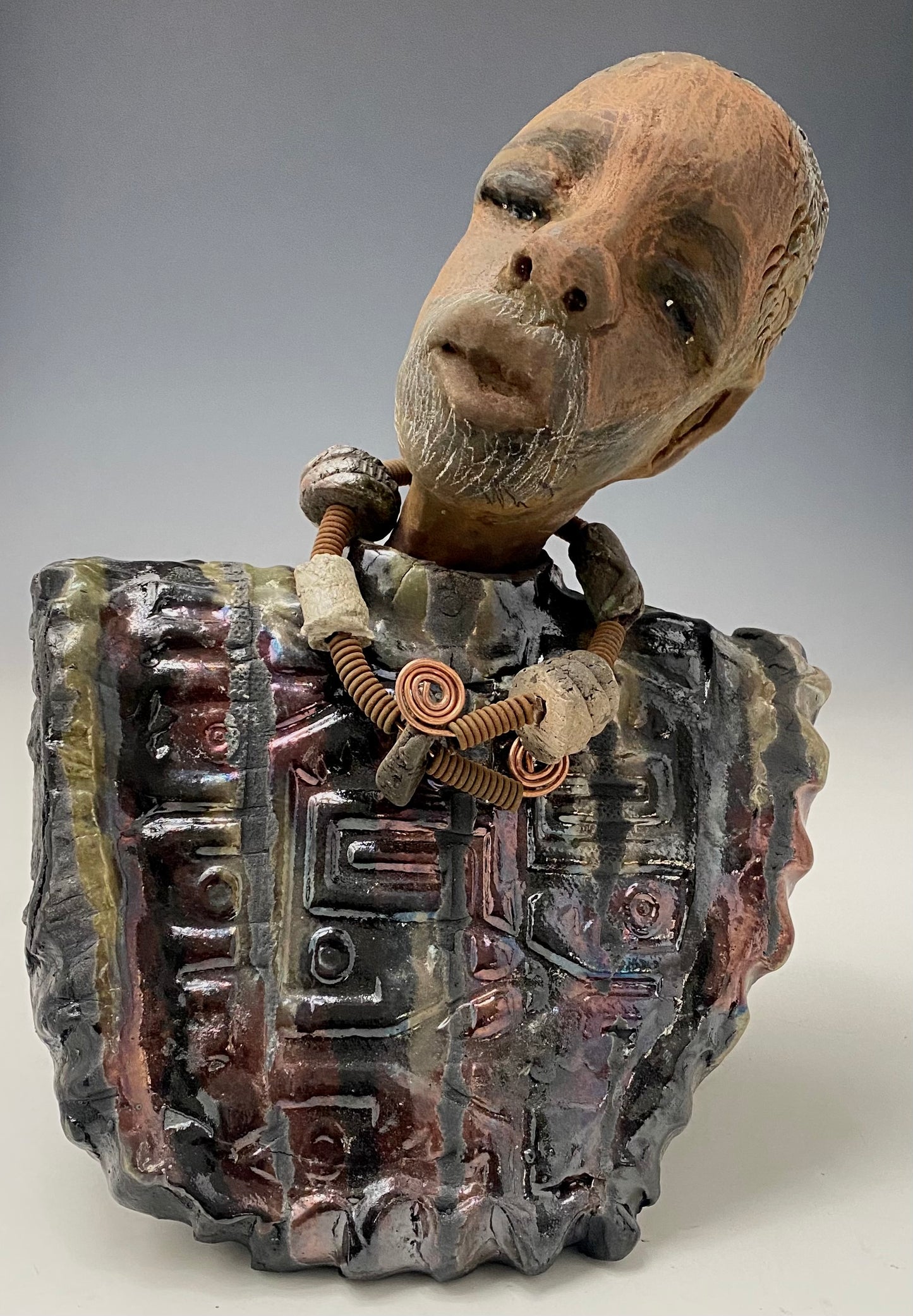 Meet James! James stands 10" x 7" x 5.5" and weighs 3.5lbs. James wears a colorful metallic gold, blue and copper dashiki. He is bald and bearded and partially grey. Yes ,,,,,,He is one of few Men found in the Herdew collection!