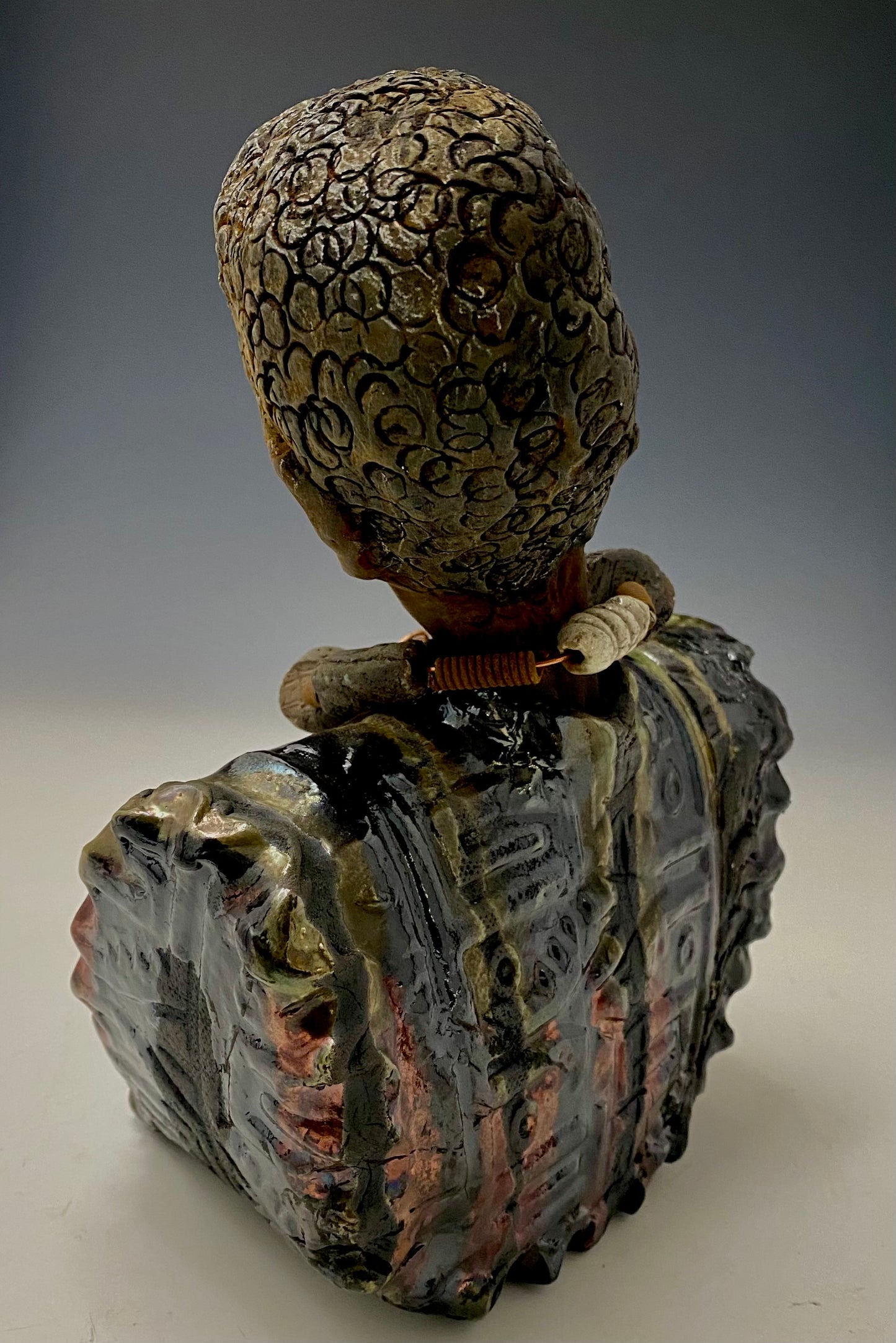 Meet James! James stands 10" x 7" x 5.5" and weighs 3.5lbs. James wears a colorful metallic gold, blue and copper dashiki. He is bald and bearded and partially grey. Yes ,,,,,,He is one of few Men found in the Herdew collection!