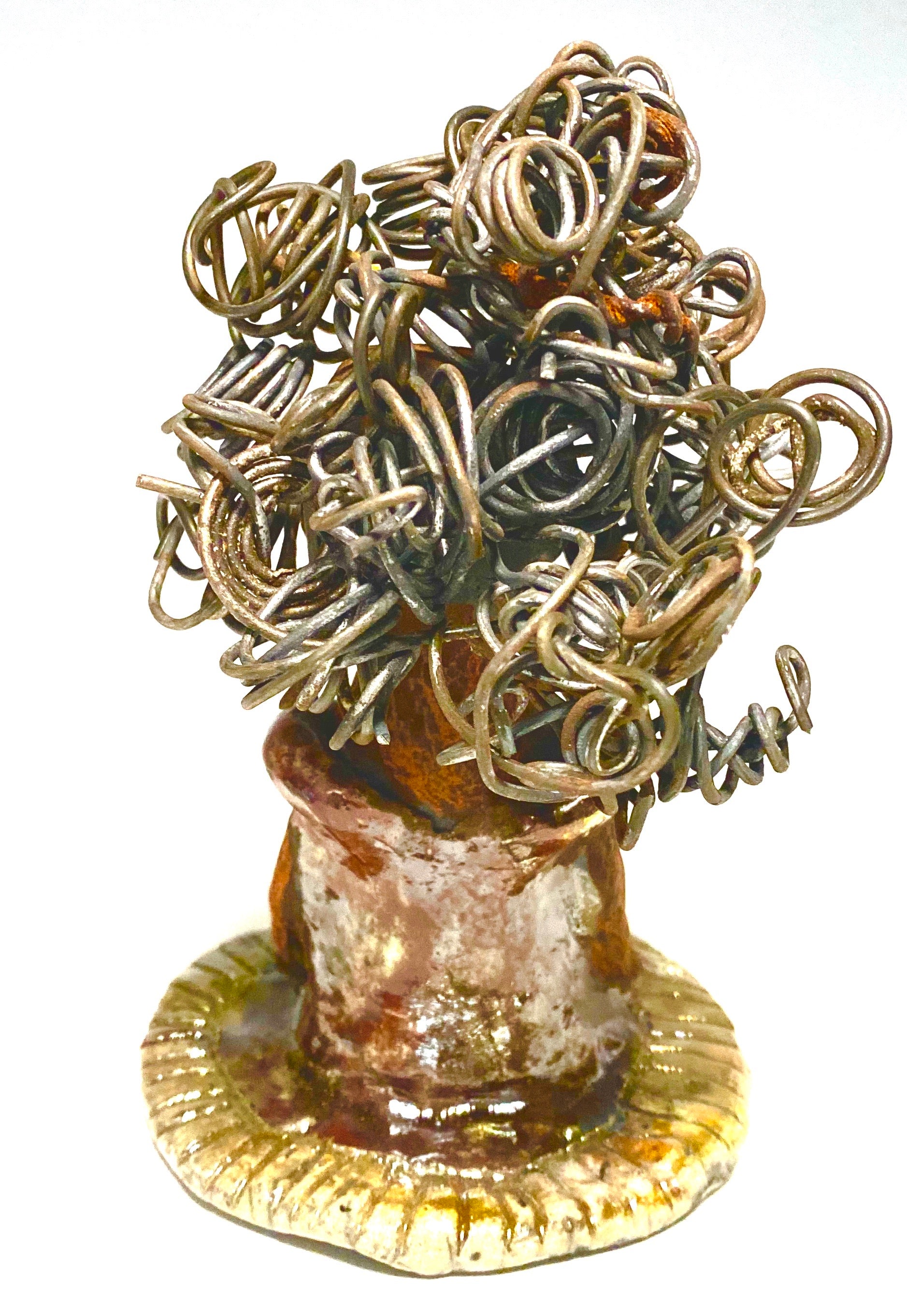 Meet Carleen! Carleen  stands 6" x 4" x 4" and weighs 12 ozs. Carleen has a honey brown complexion with 16 gauge curled wire hair. She wears an copper metallic dress. Carleen  has her long loving arms at her side as she rest and waits.