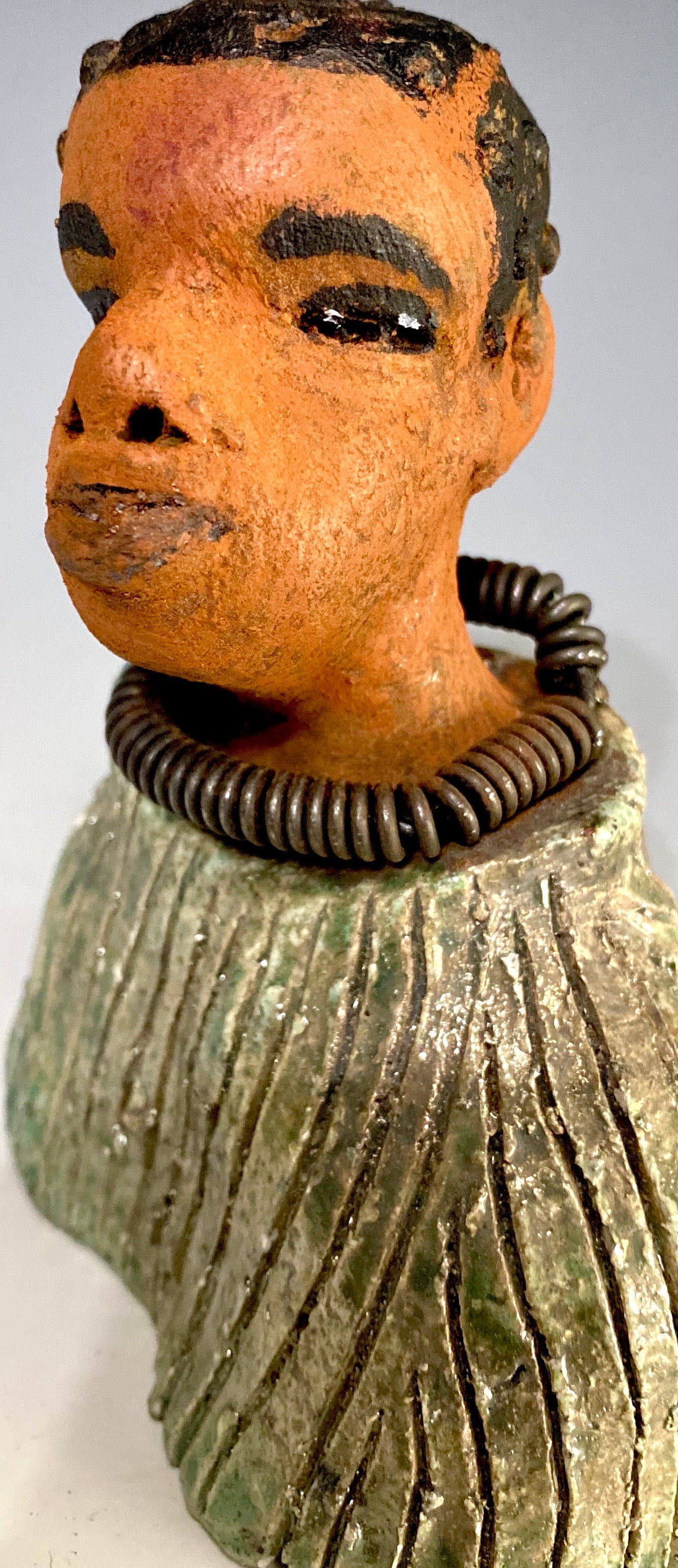 "It is obvious Herdew implies that most of my sculptures are female. My goal this year is to create ten male sculptures. Alvin is one of the first that I am pleased with. Pete stands 5" x 4" x 3" and weighs 10 ozs. He wears an etched metallic multi colored jacket with a cioled wire necklace. Pete has a honey brown complexion. Pete seems to be in deep thought about his next move in life. Pete  would display proudly in your home.