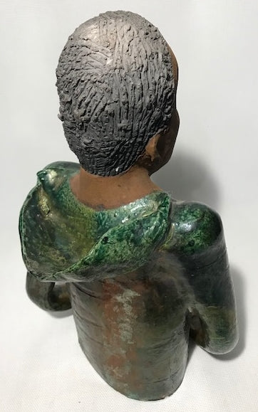 Ivani s the third young man to be introduced in this collection.     Ivan stands 17" x 9" x 10" and weighs 8.12 lbs.     Ivan has an awesome honey brown complexion.     He wears copper green hoodie     Ivan's  hair is made of  clay, black grey, and wavy.  Give Ivan a special place in your home. Free Shipping!
