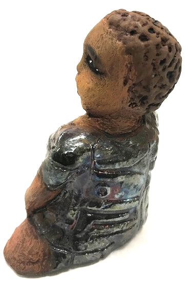 Meet Josephine! Josephine stands 6" x 5" x 3"and weighs 15 ozs. Josephine has a lovely honey brown complexion with big bright eyes. She wears a low cut  hairdo  - Herdew. Her dress is patterned with a metallic copper glaze. Josephine has her long loving arms at her side. Josephine will make a great gift or a starter piece From the Herdew Collection!