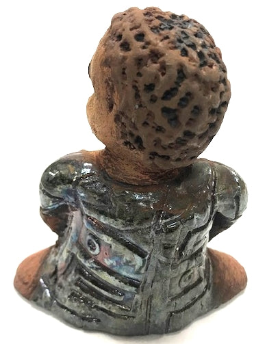 Meet Josephine! Josephine stands 6" x 5" x 3"and weighs 15 ozs. Josephine has a lovely honey brown complexion with big bright eyes. She wears a low cut  hairdo  - Herdew. Her dress is patterned with a metallic copper glaze. Josephine has her long loving arms at her side. Josephine will make a great gift or a starter piece From the Herdew Collection!