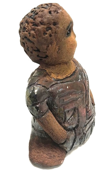 Meet Josephine! Josephine stands 6" x 5" x 3"and weighs 15 ozs. Josephine has a lovely honey brown complexion with big bright eyes. She wears a low cut  hairdo  - Herdew. Her dress is patterned with a metallic copper glaze. Josephine has her long loving arms at her side. Josephine will make a great gift or a starter piece From the Herdew Collection!