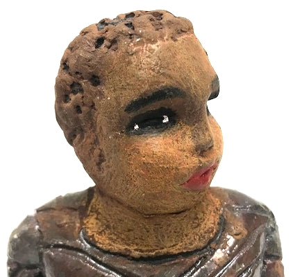 Meet Josephine! Josephine stands 6" x 5" x 3"and weighs 15 ozs. Josephine has a lovely honey brown complexion with big bright eyes. She wears a low cut  hairdo  - Herdew. Her dress is patterned with a metallic copper glaze. Josephine has her long loving arms at her side. Josephine will make a great gift or a starter piece From the Herdew Collection!