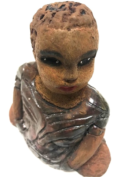 Meet Josephine! Josephine stands 6" x 5" x 3"and weighs 15 ozs. Josephine has a lovely honey brown complexion with big bright eyes. She wears a low cut  hairdo  - Herdew. Her dress is patterned with a metallic copper glaze. Josephine has her long loving arms at her side. Josephine will make a great gift or a starter piece From the Herdew Collection!