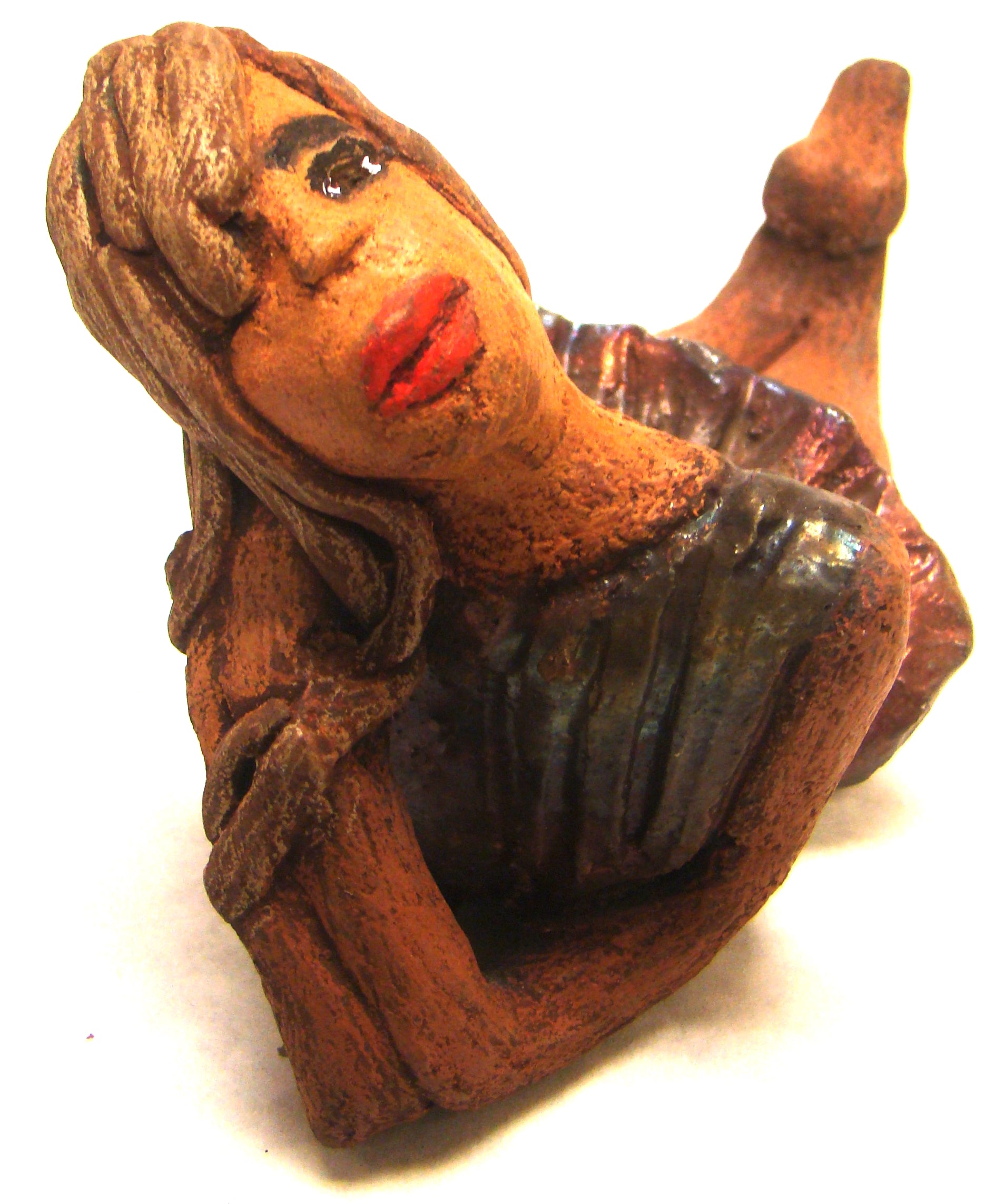 Juanita  stands 4" x 3" x 7" and weighs 1 lb.     She has a lovely honey brown complexion.     Juanita has a copper iridescent  dress.     Her long loving arms rest underneath her face as she  caresses her brown clay hair.     Juanita will definitely get your guest attention and create conversation.