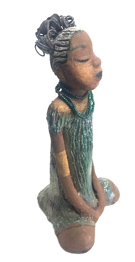 Meet Katie!      Katie stands 12" x 6.5" x 5.5"and weighs 2.13 lbs.     Katie has a lovely two tone honey brown complexion.     She has a nice wire pony tail behind her smokey black hair.     Katie has a gold band around her long loving arms.     Her dress is an alligator green with streaks of copper.     Katie wears an emerald beaded necklace.  Katie sits patiently and  waits on a new home. Free Shipping!