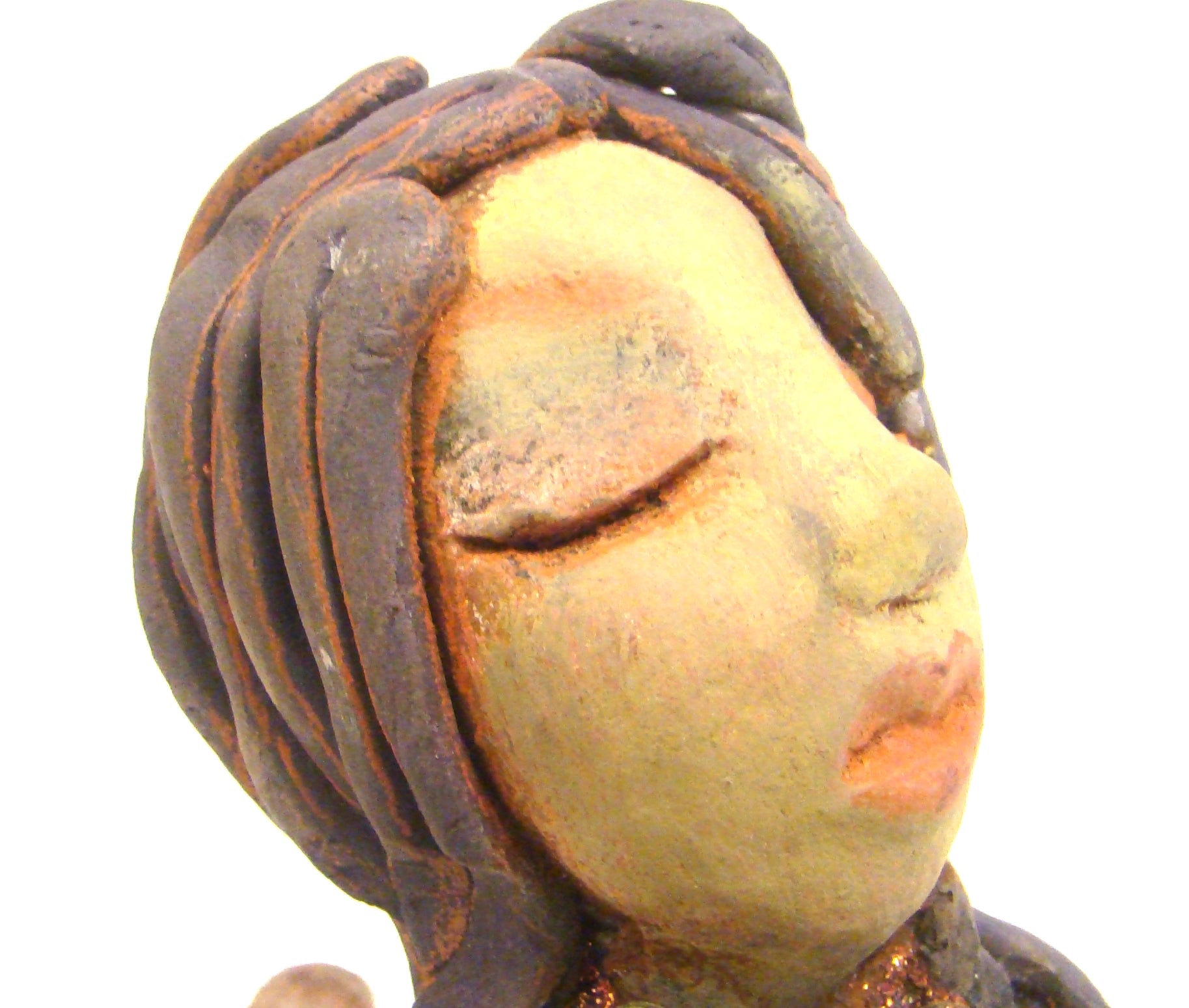 Lacey stands 6" x 3" x 7.5" and weighs 1.08 lbs. She has a lovely beige olive green complexions with ruby red lips. Her hair is made of coiled clay. Lacey is holding her handbag which matches her copper glittered dress. Give Lacey a special place in your home.